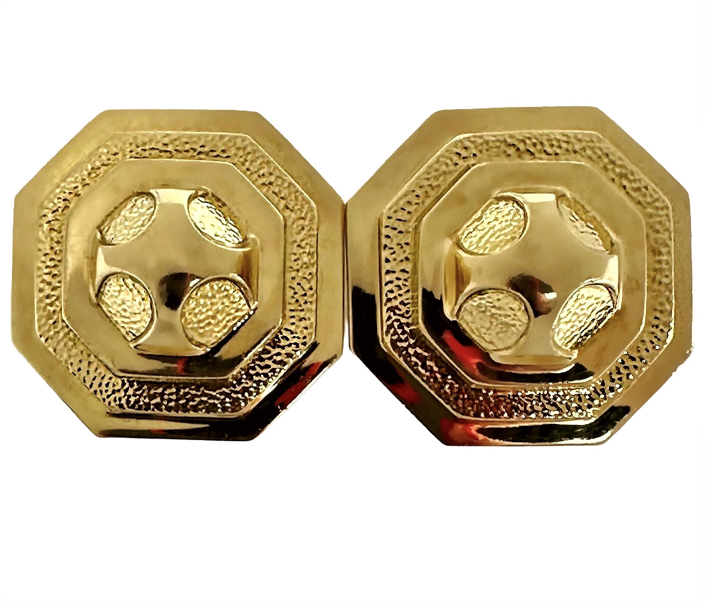 This large pair of vintage, David Webb 18K yellow gold earrings has a combination of finishes.  The two texture 9/16 inch diameter domes in the center are surround by an octagonal step design, with alternating high polish and stippled textures,