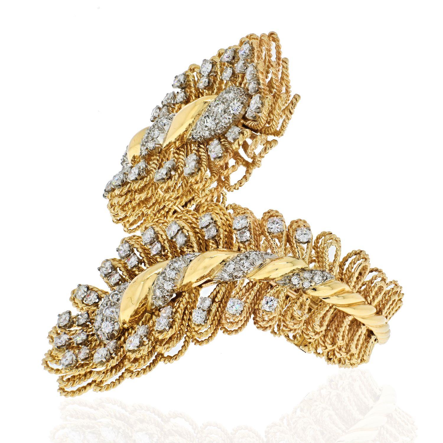 Beautiful vintage crossover David Webb cuff bracelet made in 18K Yellow Gold and Platinum. Hinged closure, perfect for wrist sizes from 6.25 to 6.75 inches. 
Round cut diamonds approx. 10 carats. 
Quality F-G color, VS-SI clarity. 

