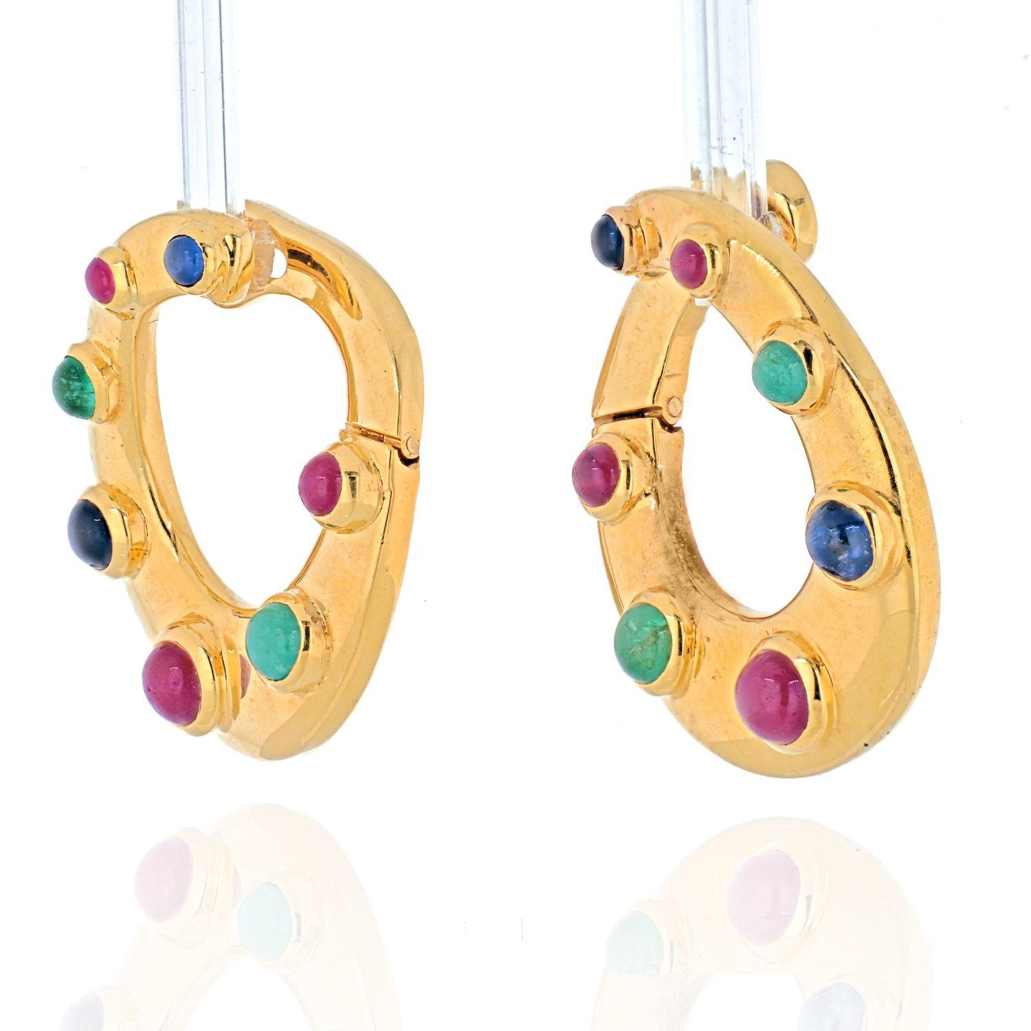 A pair of David Webb 18K Yellow Gold Oval Shaped Sapphires, Emeralds and Rubies Earrings.
This is an exciting pair of earrings with the gold that was finished sonewhat flat, therefore making these earrings nice and light. Mounted with bright colored