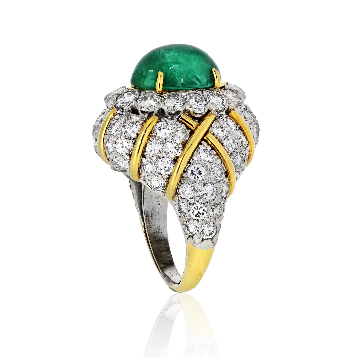 A deep hue green emerald cabochon set in an oval halo of round brilliant white diamonds is the focal point of this bombé cocktail ring, which features quilt-like crosshatching made of gold with pavé-set diamonds. Approx. 6.50cts of