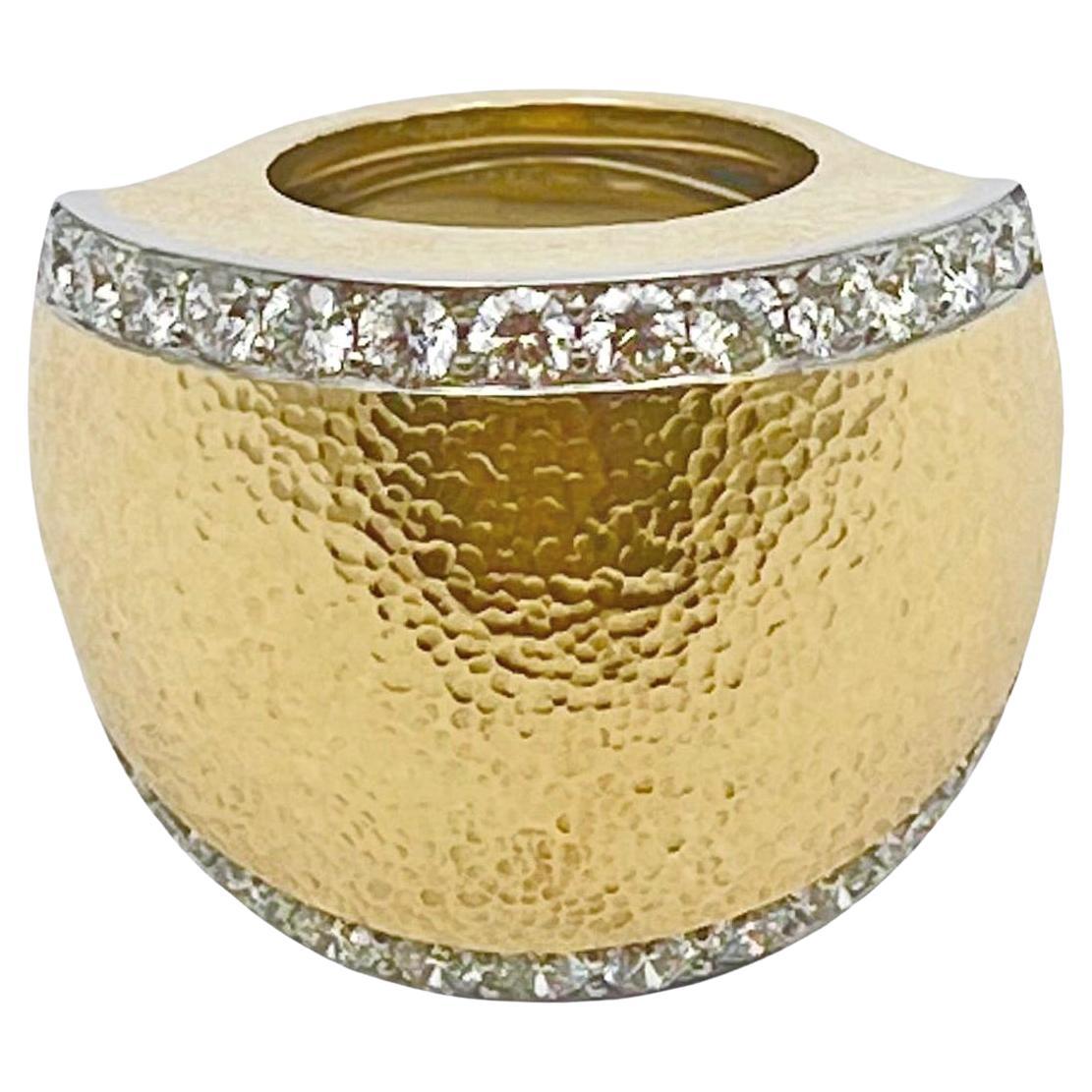 David Webb tapered dome ring in hammered 18k yellow gold with platinum borders on either side accented by round brilliant-cut diamonds.  Twenty-six diamonds weighing approximately 2.60 total carats (G color, VS1-VS2 clarity).  Signed 