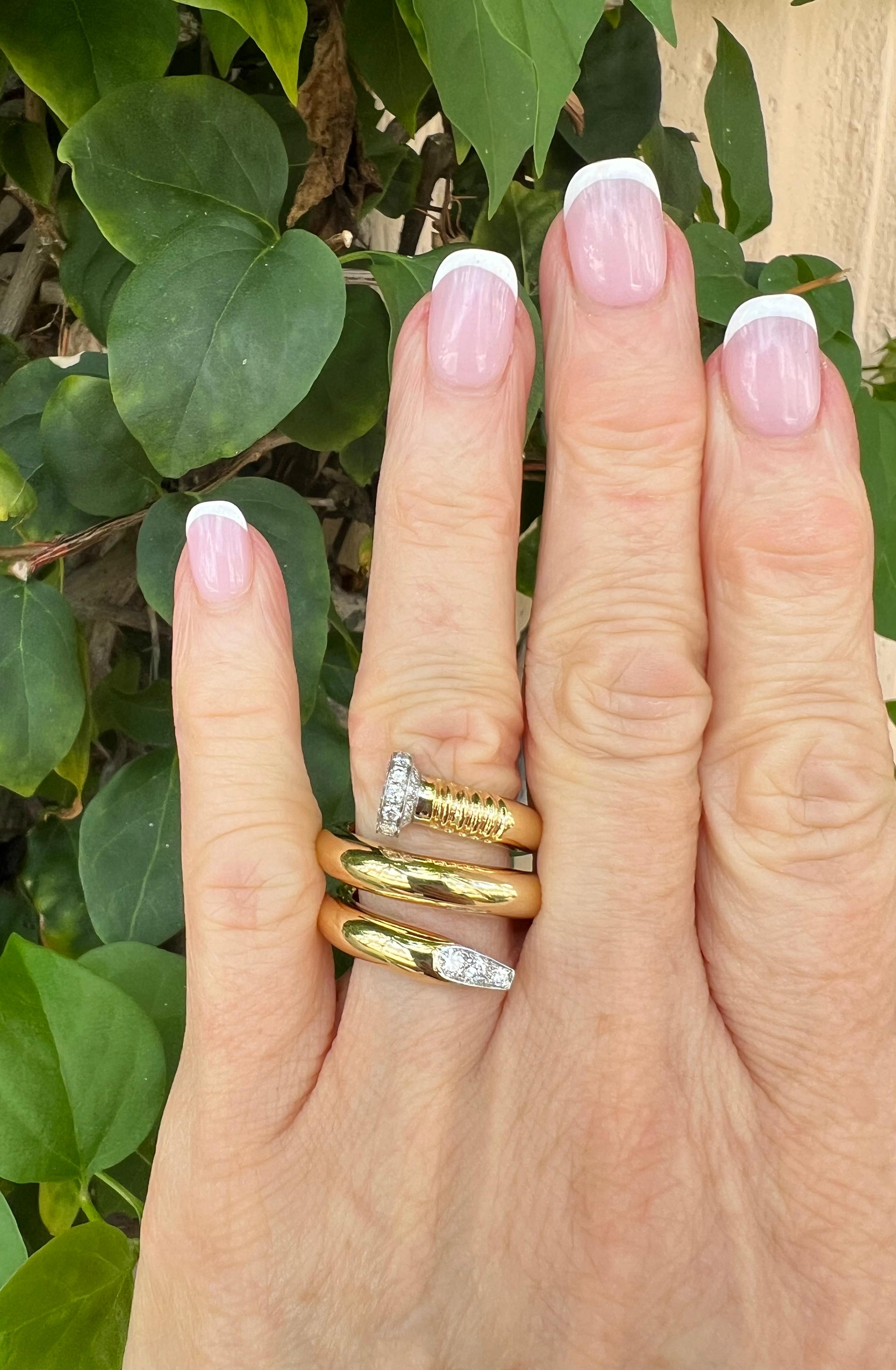 David Webb's iconic 'Nail' wrap ring, designed as a polished 18k yellow gold wrapped nail with platinum tips accented by twenty-two round brilliant-cut diamonds weighing approximately 0.75 total carats (E-F color, VS1-VS2 clarity).  Signed ' © David