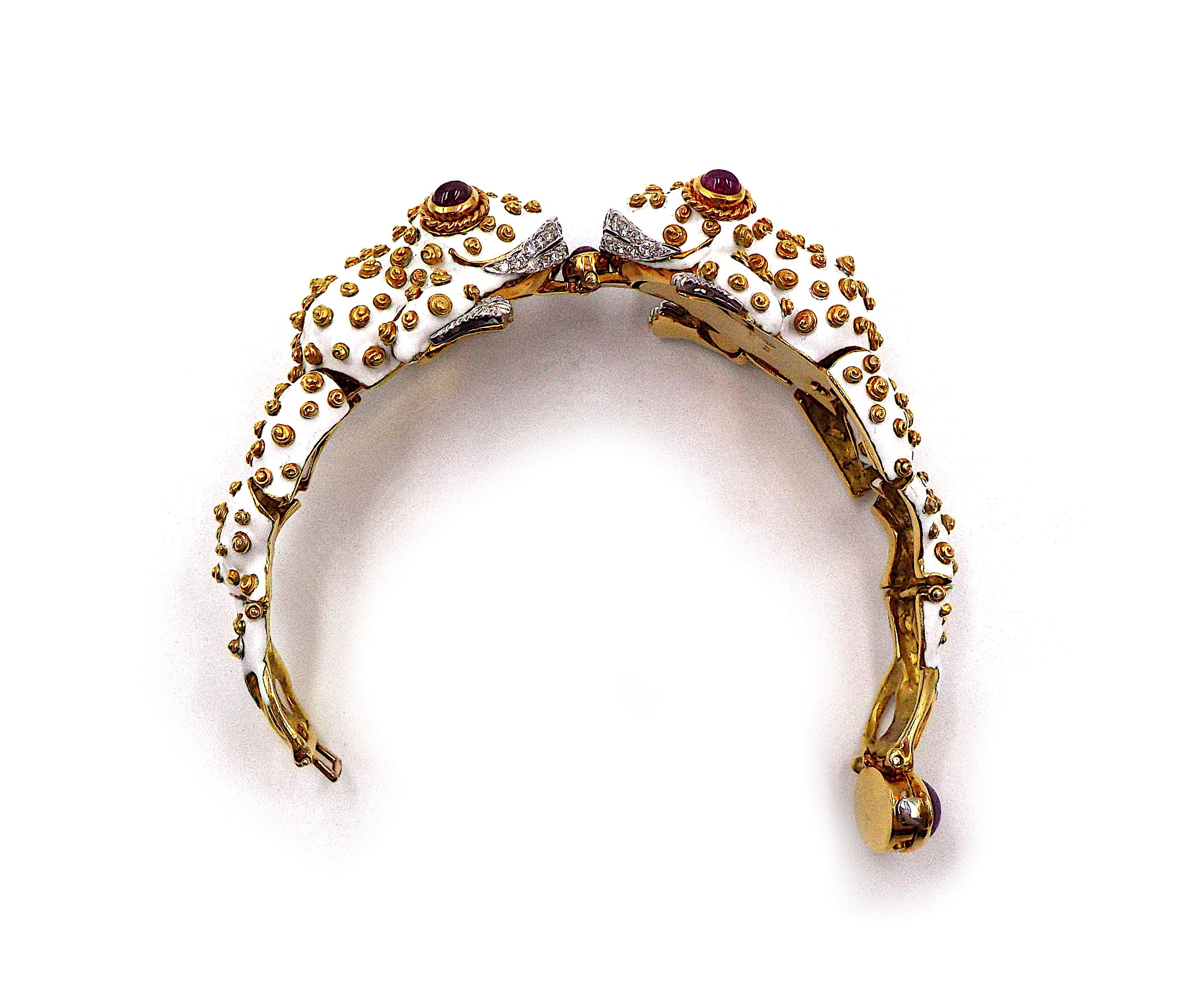 A fancy twin frog shaped bracelet by David Webb. Cabochon rubies, brilliant-cut diamonds, white enamel, 18K gold, and platinum. Gross weight is approximately 113.7g, inner circumference is approximately 6.75 inches. Signed Webb, marked 18K, Plat.