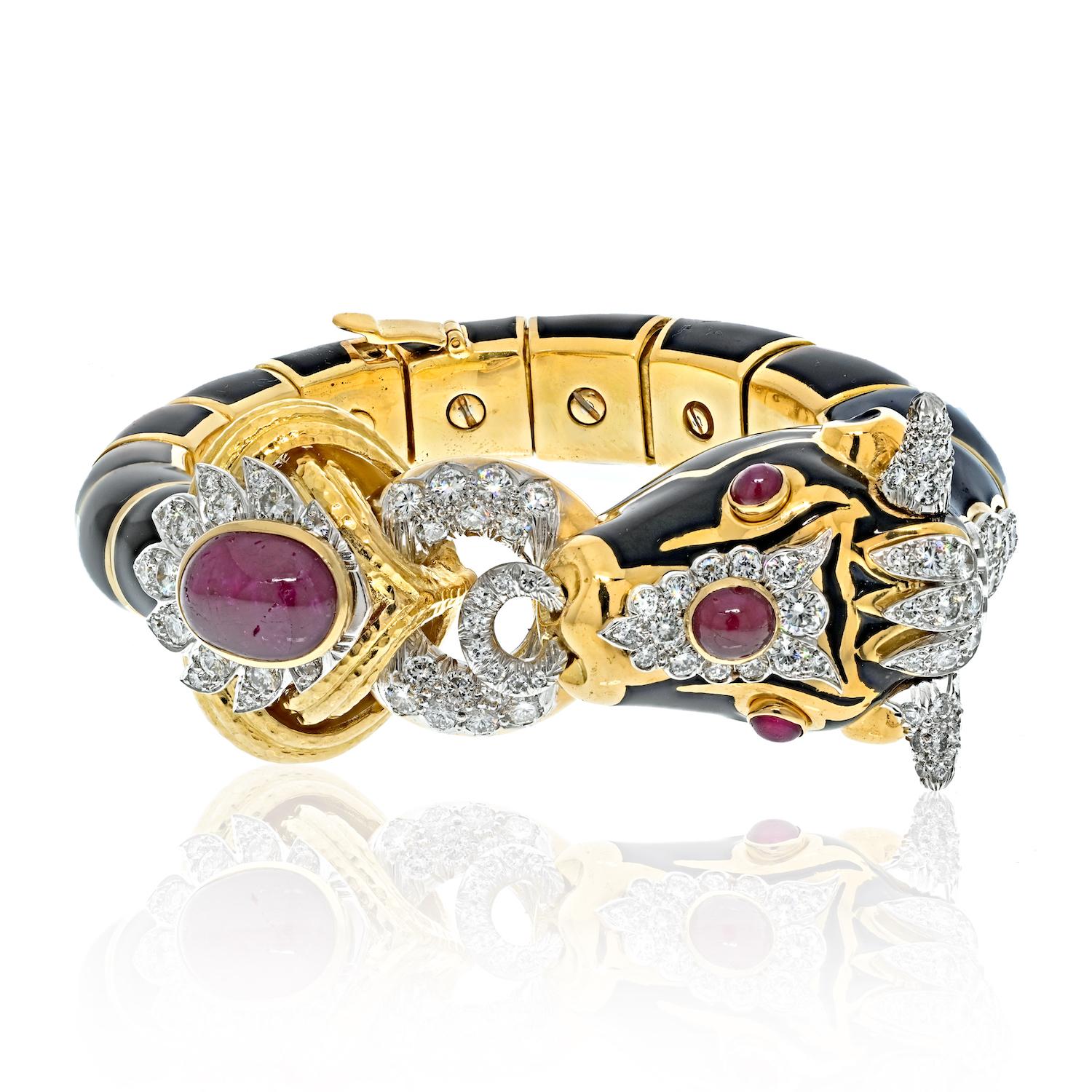 The David Webb Platinum & 18K Yellow Gold Black Enamel Red Ruby Diamond Bull Bracelet is a stunning piece of jewelry that exemplifies the extraordinary craftsmanship and attention to detail that the David Webb brand is known for. This exquisite