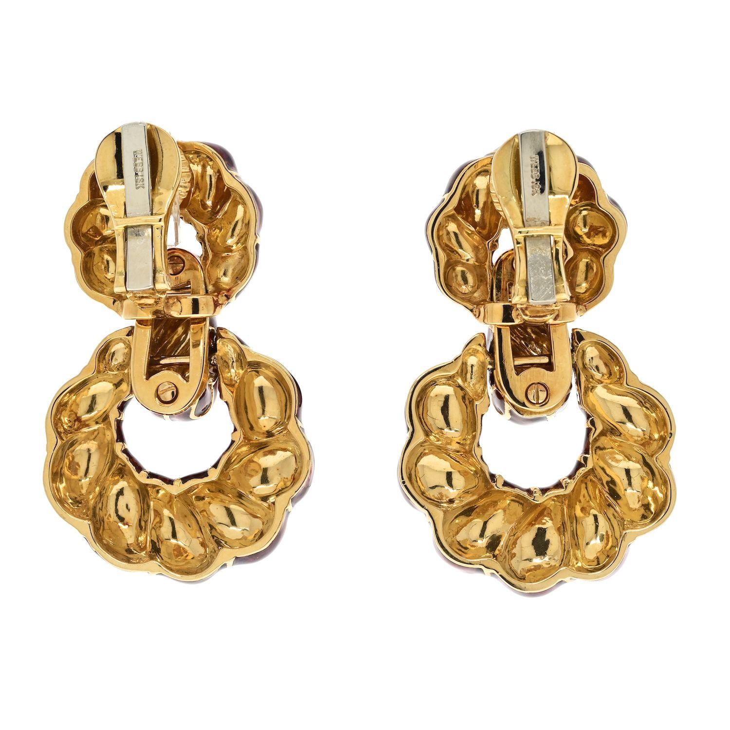 The David Webb Platinum & 18K Yellow Gold Fluted Red Enamel Door Knockers Clip Earrings are a bold and striking pair of earrings that capture attention with their unique design and vibrant color. Crafted in a combination in 18K yellow gold, these