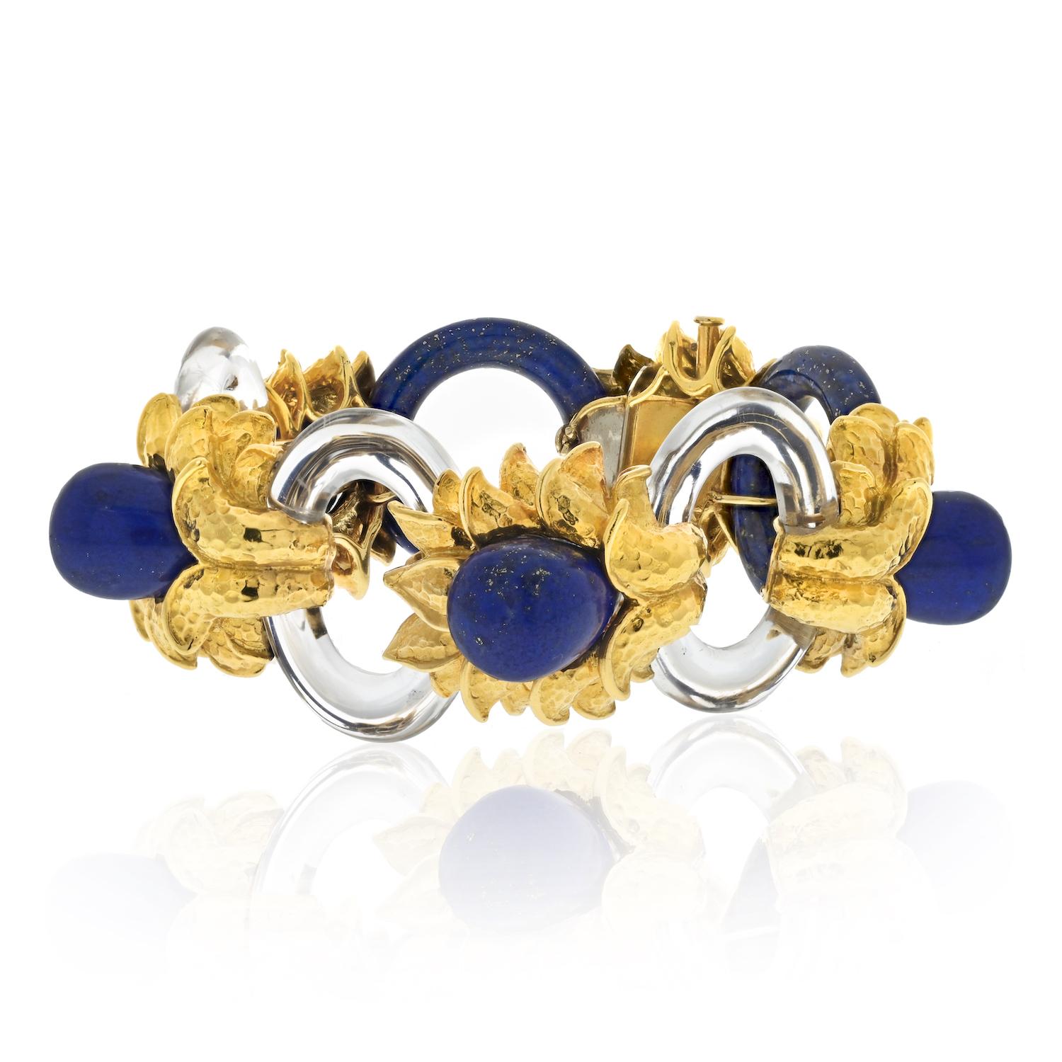 The David Webb 18k yellow gold bracelet is a striking piece of jewelry that showcases the brand's expertise in design and craftsmanship. Featuring a unique combination of materials, this bracelet is designed with three carved oval rock crystal