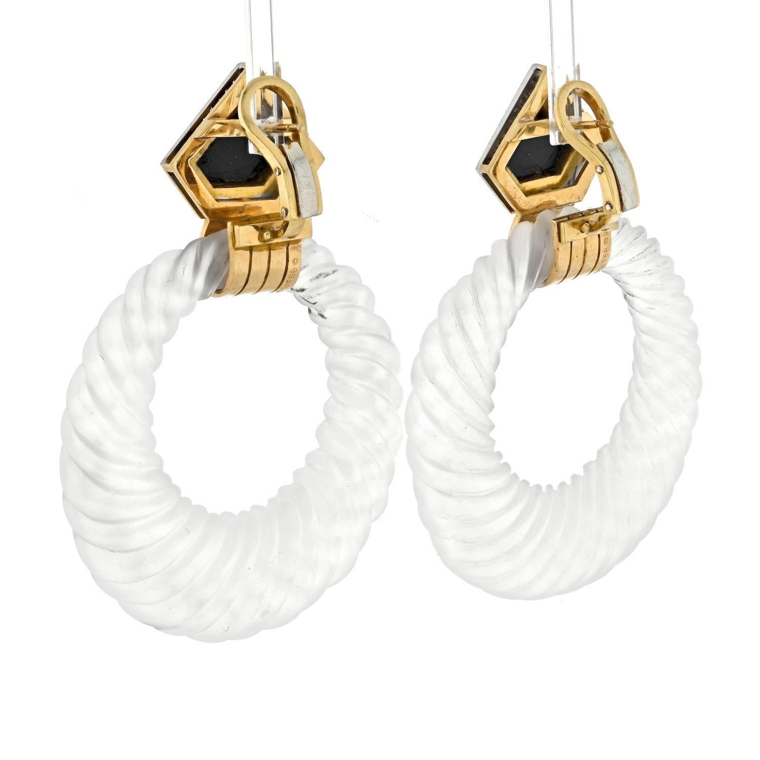 The description paints a vivid picture of an exquisite pair of earrings that exemplify the distinctive design and craftsmanship associated with David Webb. Let's break down the details:

**Design and Materials:**
- **Shield-shaped Surmount:**
  The