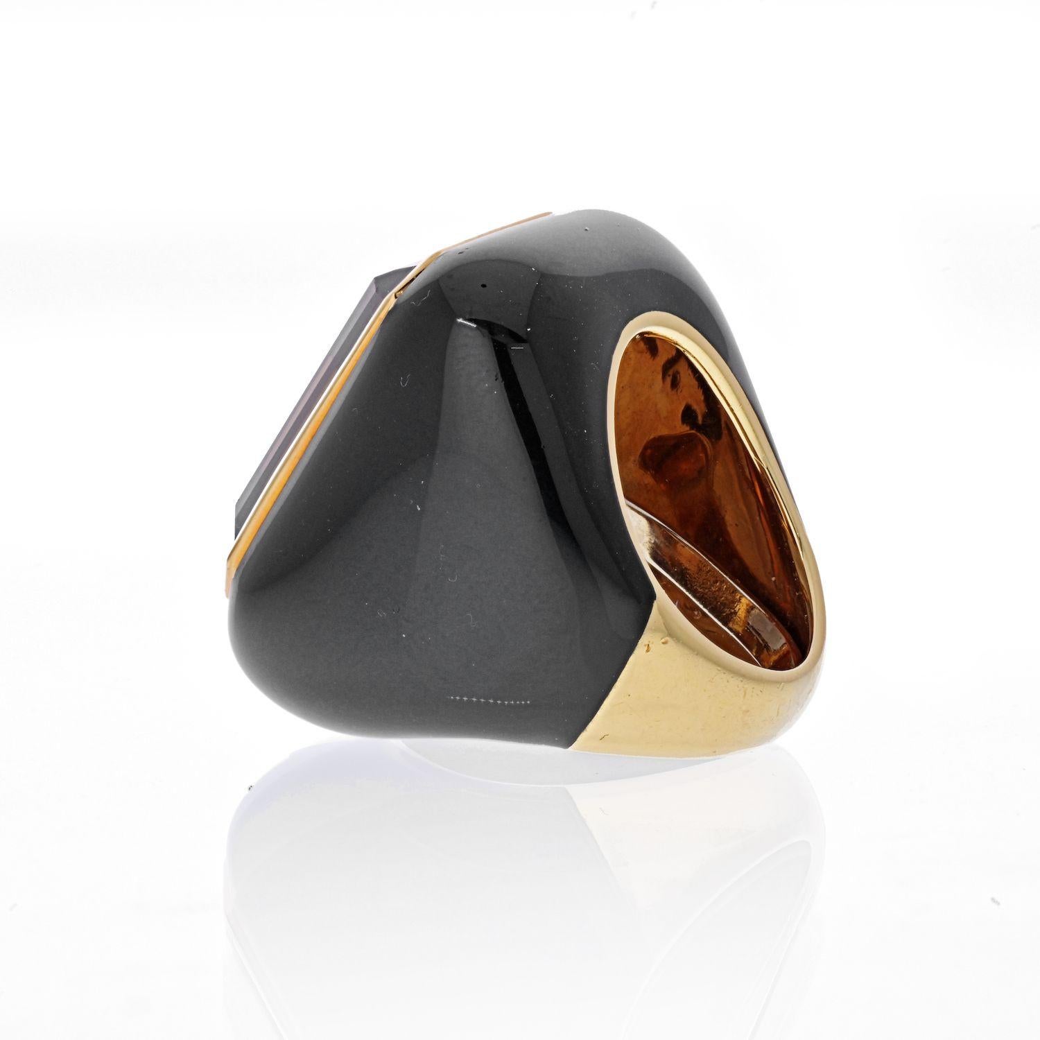 David Webb smoky quartz ring centering one emerald-cut smoky quartz ap. 20.00 cts., framed by polished gold, within a cushion-shaped mount of black enamel, signed Webb, ap. 17.2 dwts. gross. Size 5 1/2, with inner guard. With signed pouch.

Overall