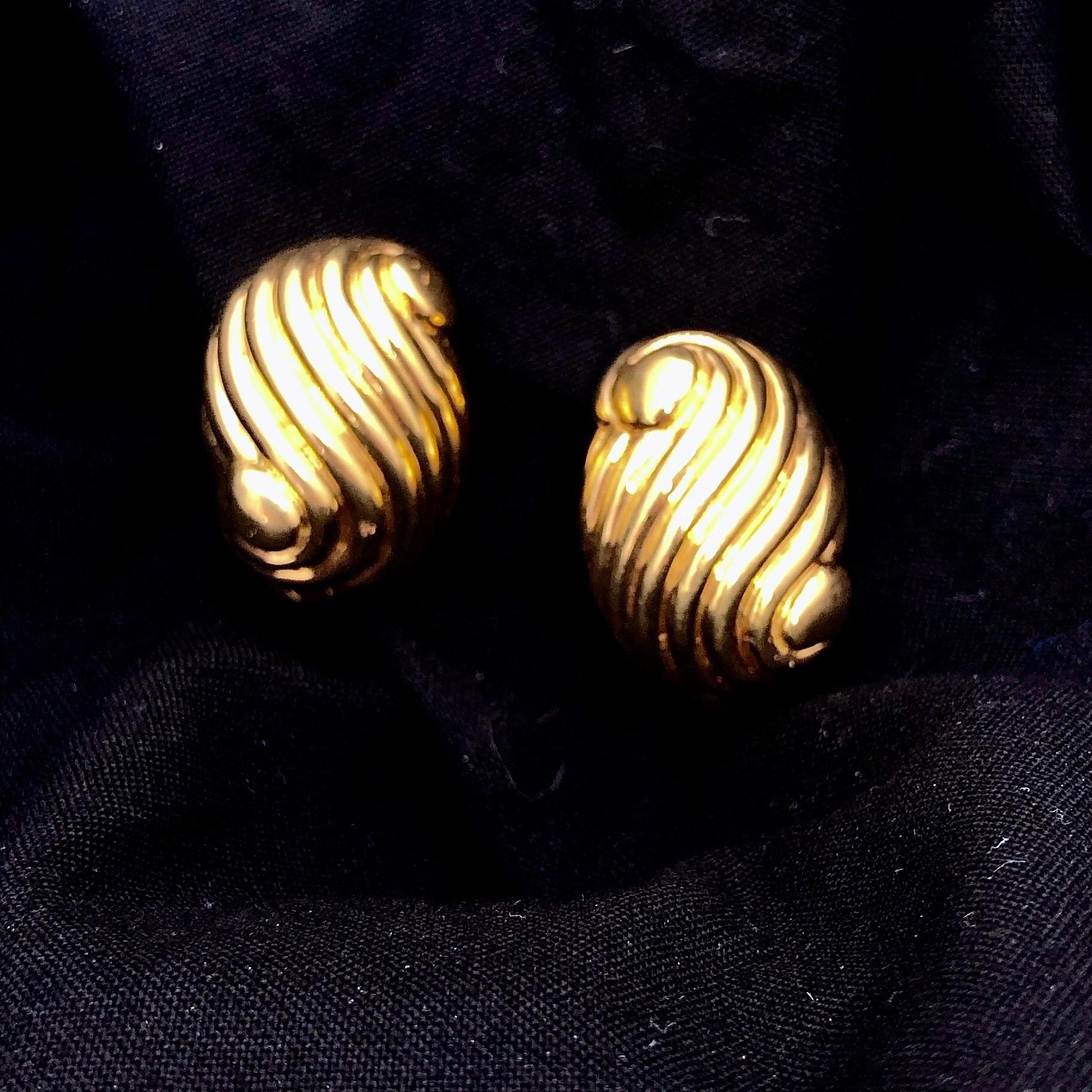 This vintage pair of David Webb, 18k gold earrings are melon fluted in such a clever way as to create a pleasing visual sense of motion. They are substantial, measuring 1 1/8 inches top to bottom and 3/4 inches in width. Earring backs are struck