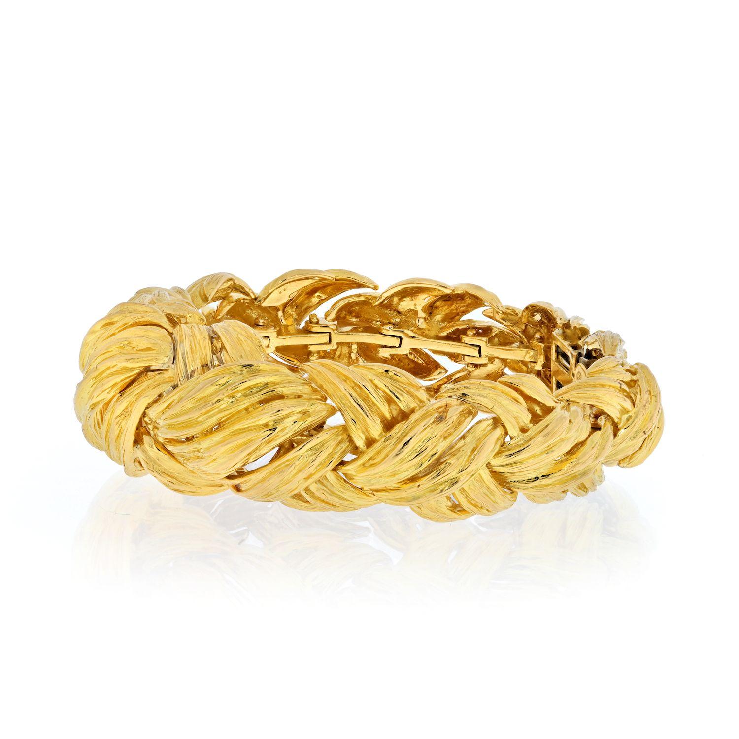 David Webb 18K Yellow Gold woven rope bracelet inner circumference 6.5 inches. 
This classic gold power bracelet features iconic David Webb architectural interest with its interwoven yellow gold detail. Mix it with lots of yellow gold for a festive