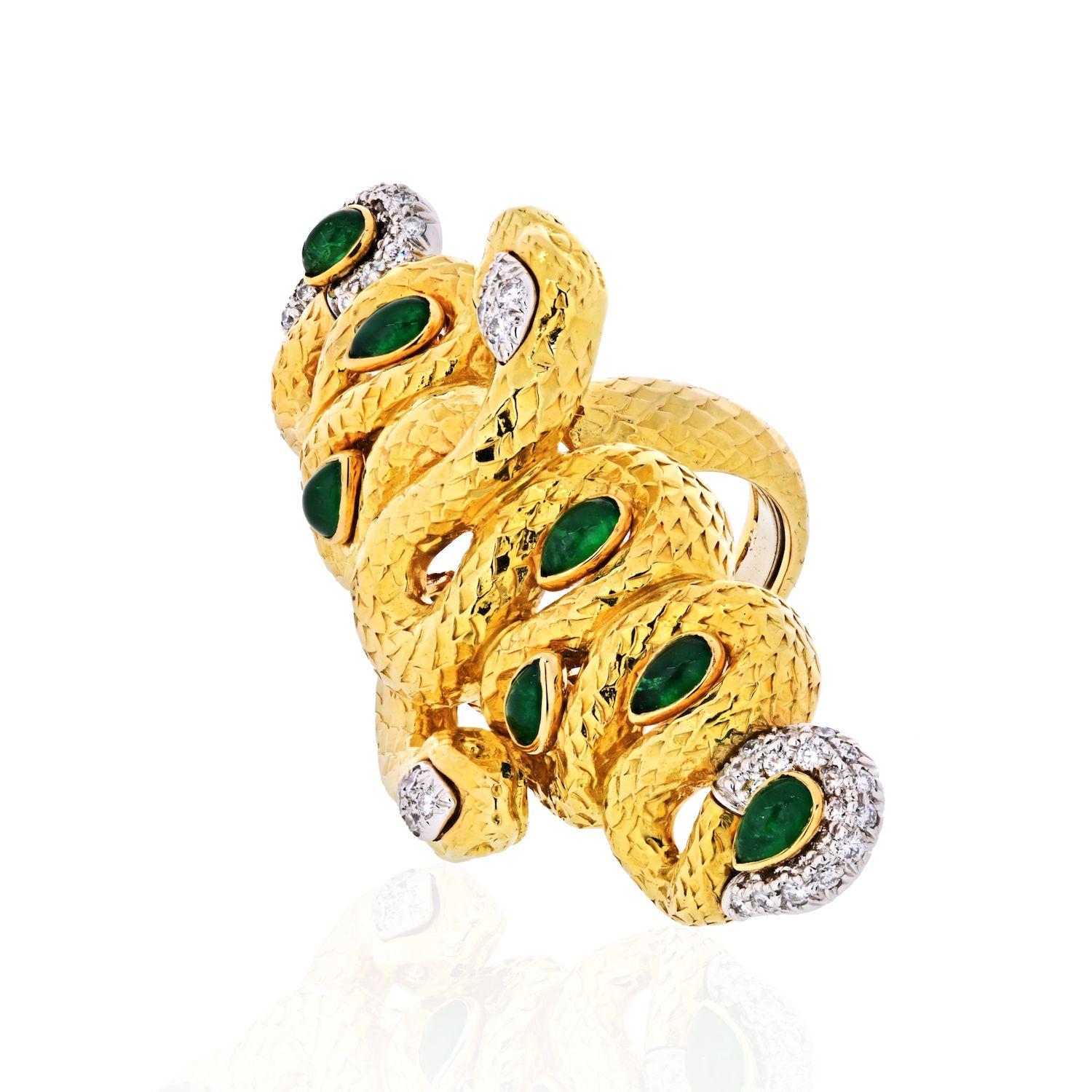 Get lucky with this almost impossible to find David Webb two golden snakes ring. Two substantial size serpents are intertwined and wrapped together creating one intricate look. Set with cabochon emeralds and diamonds the two snakes double headed