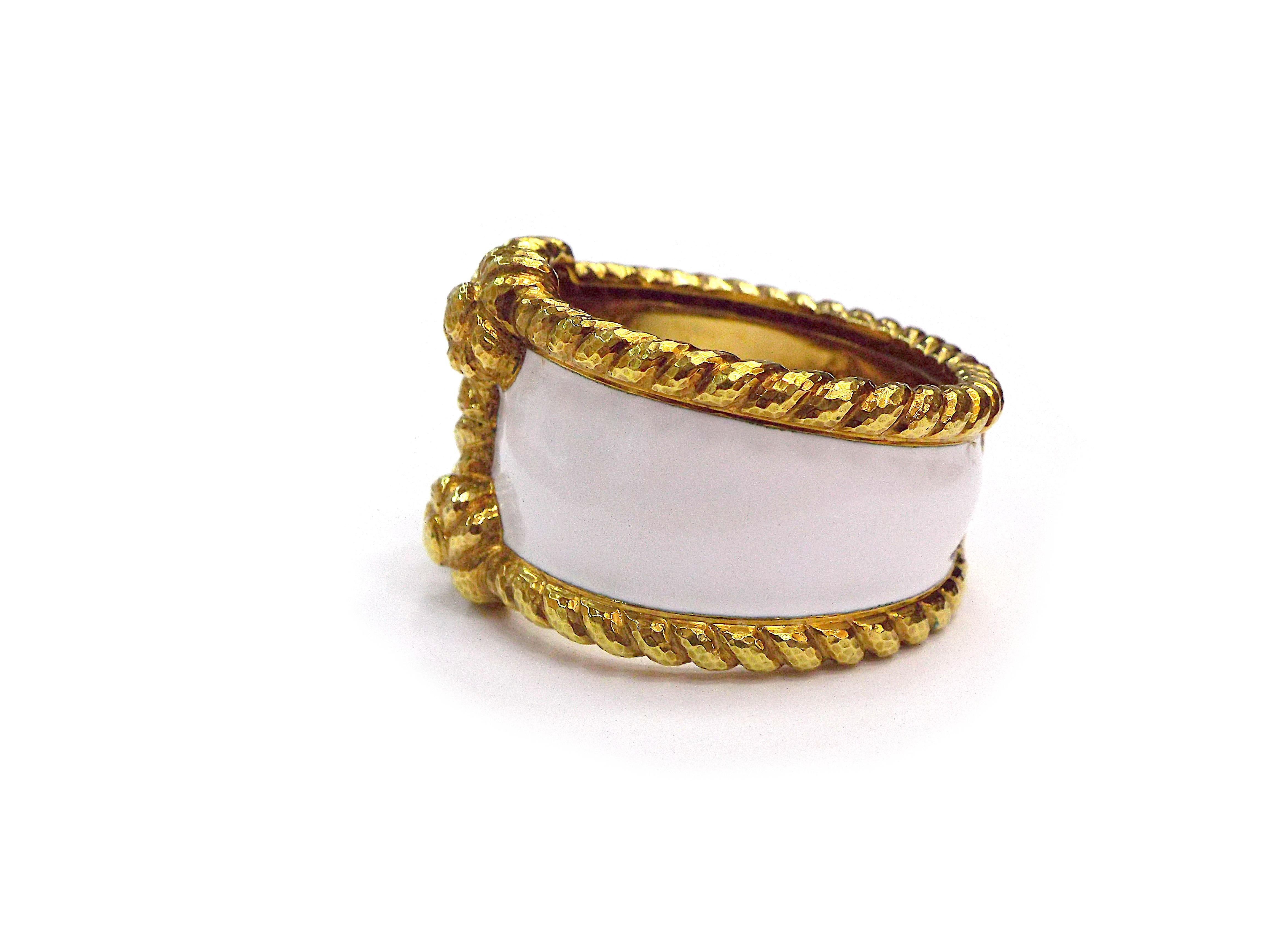A chic bracelet by David Webb performed in 18K yellow gold and white enamel. Inner circumference is approx. 6.5 inches, weight is approx. 1317 grams. Signed Webb, marked 18K.