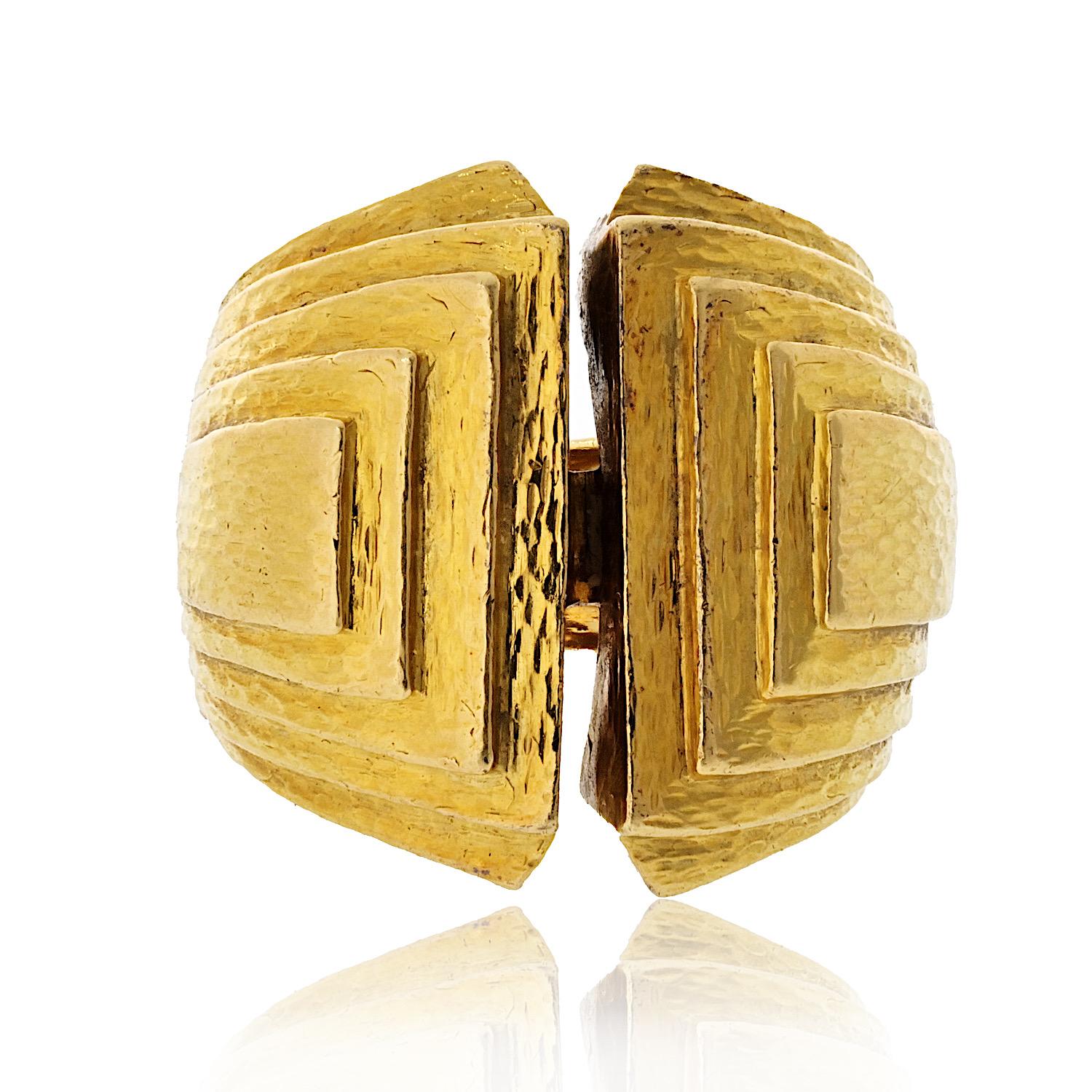Introducing the David Webb 18K Yellow Gold Bark Finish Estate Step Ring. This stunning piece features a unique hinged shank mechanism, which includes a discreet hinge on the underside of the band. This innovative design allows the ring to open