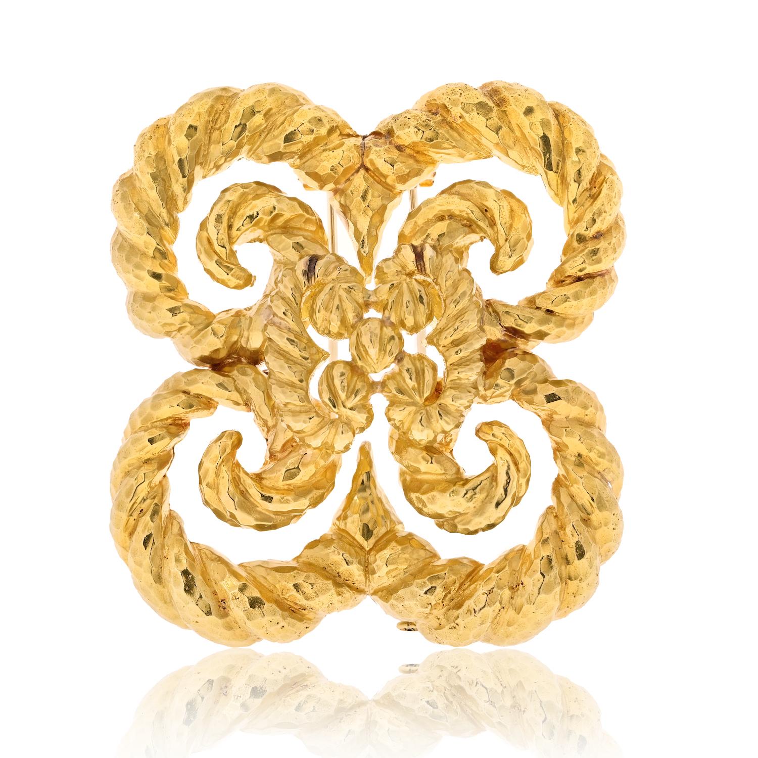 Introducing the exquisite designer brooch by David Webb, a true masterpiece in textured 18k yellow gold. This captivating brooch showcases the brand's impeccable craftsmanship and distinct design aesthetic, making it a truly remarkable