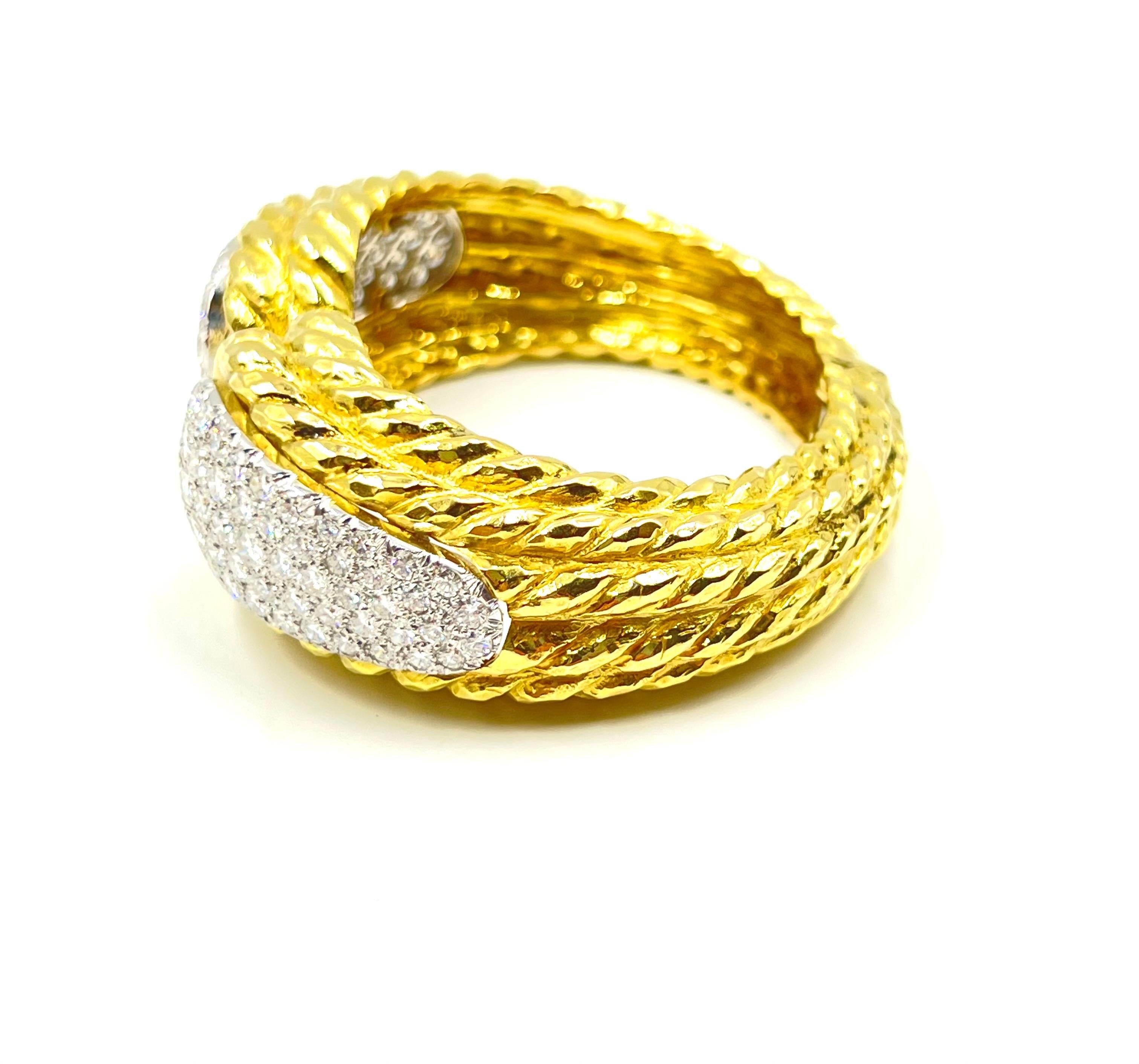 David Webb hinged cuff bracelet, featuring a pavé-set round brilliant-cut diamond section at either end, the diamonds set in platinum and bangle in 18k yellow gold with ribbed sides. Stamped 