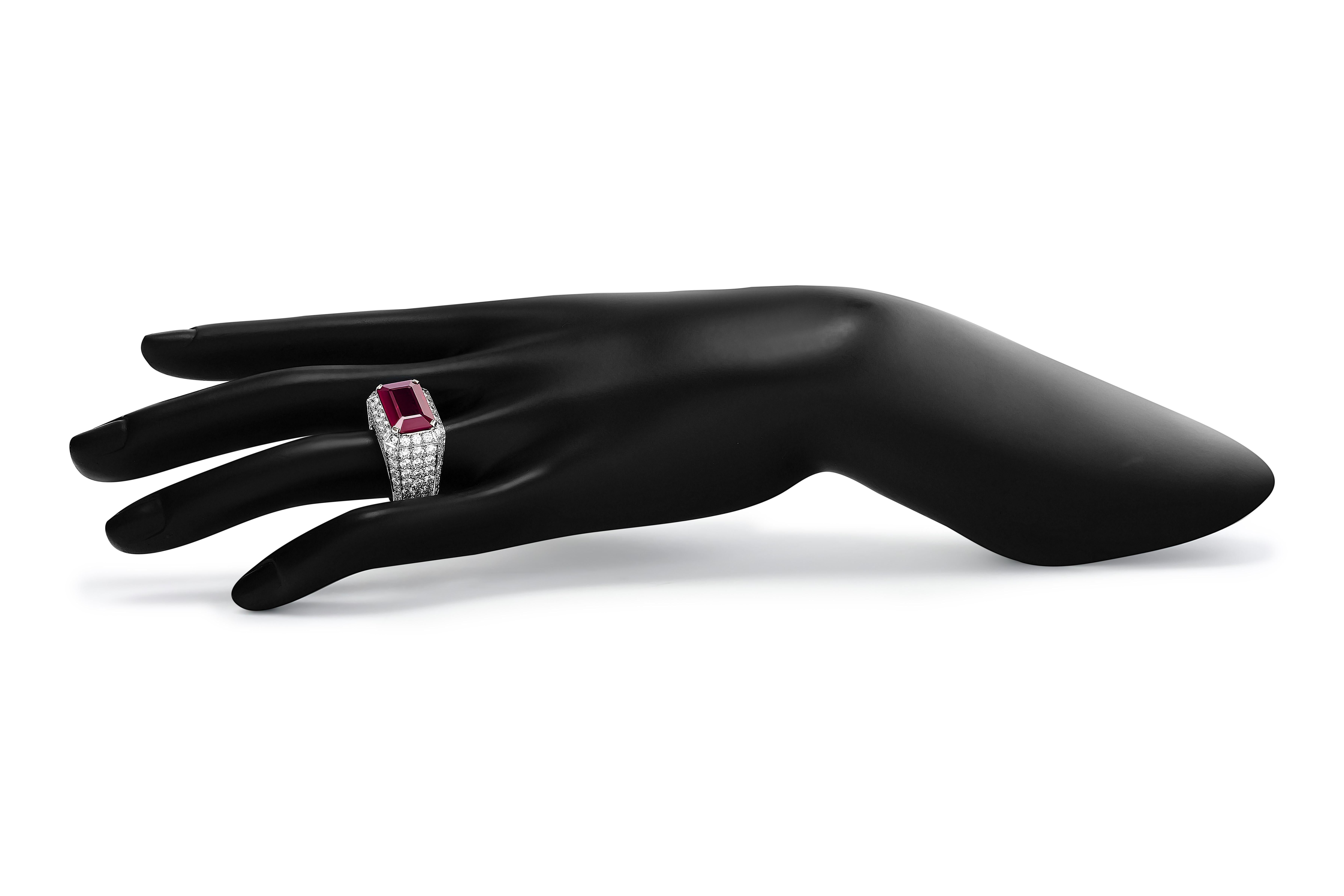 Make a bold statement with David Webb's exquisite large ruby ring, adorned with sparkling pavé-set diamonds. A stunning fusion of opulence and artistry, perfect for any occasion.

The centerpiece of this ring is a beautiful ~7.22 carat emerald cut