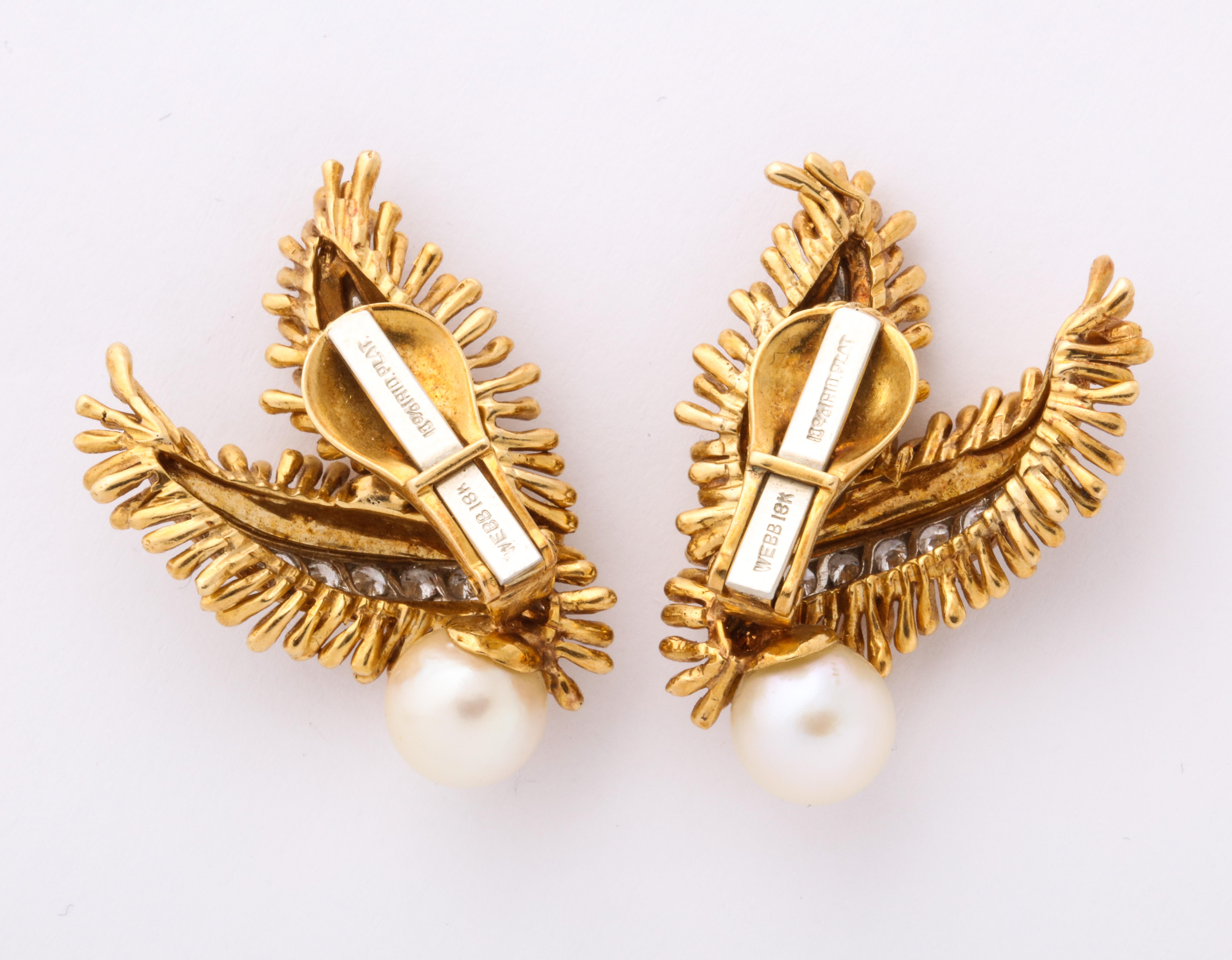 Elegant and versatile 1960s David Webb ear clips of 18K gold fringed leaf shapes set with sparkling diamonds in platinum channels, each holding a single pearl. Measuring 3/4 in x 1 1/4 inch. Gold and platinum mark. Webb mark. Gold weight of 22.7