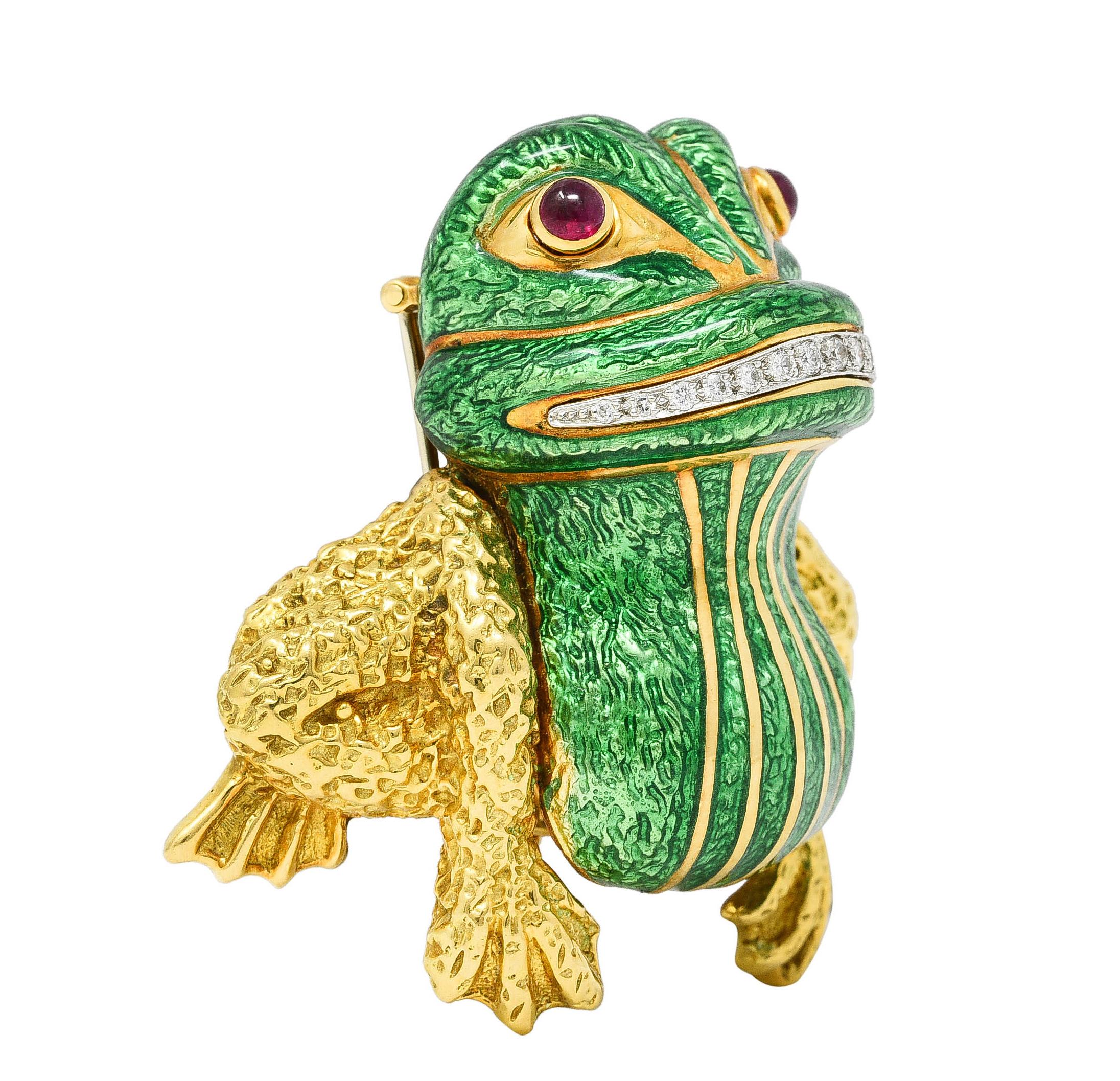 Designed as a stylized cartoonish frog featuring a smile comprised of round brilliant cut diamonds. Weighing approximately 0.20 carat total - eye clean and bright. Bead set East to West in platinum below ruby cabochon eyes. Bezel set in gold and