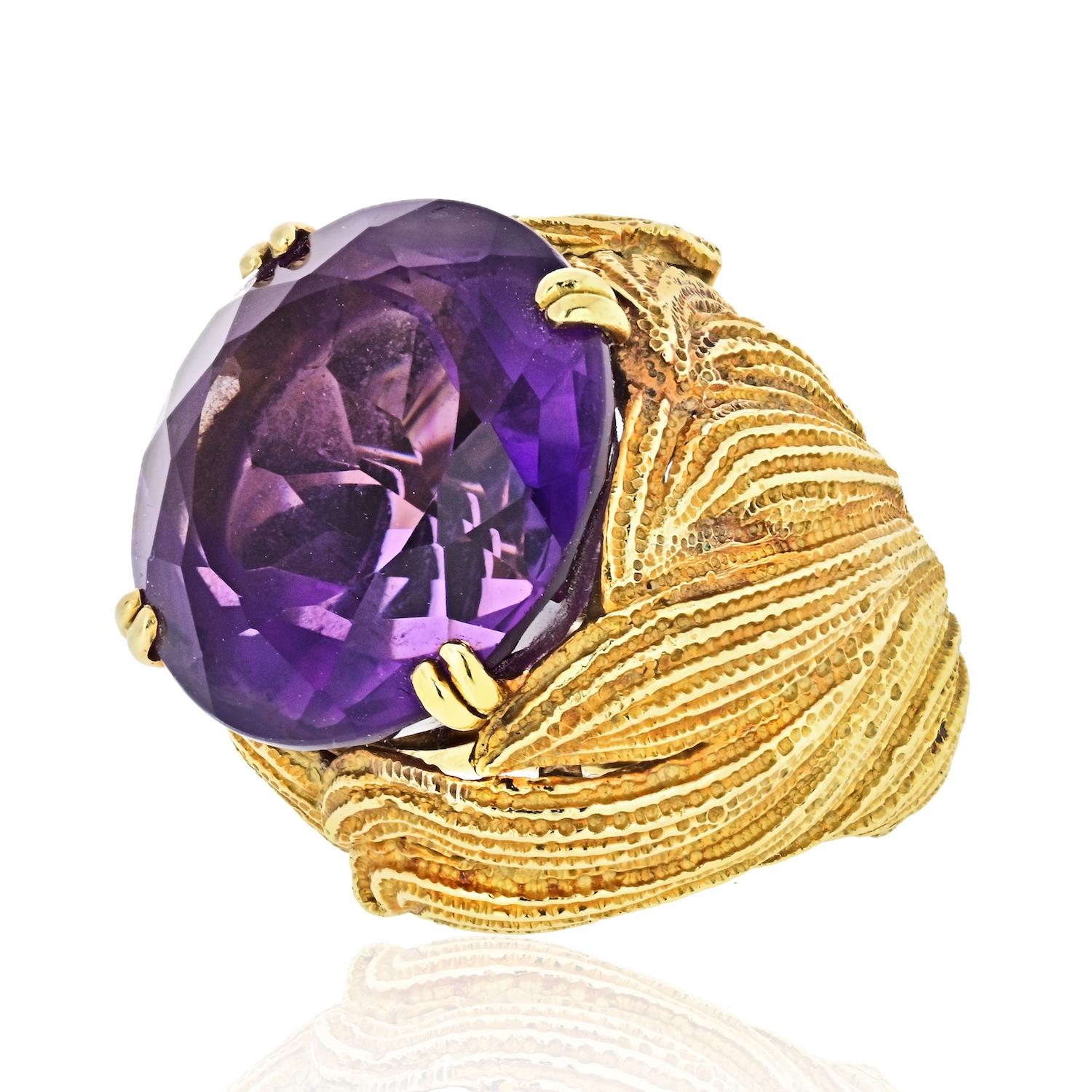 This superb quality purple amethyst hand crafted in 18 k yellow gold mounting by David Webb was created in 1970s.  
 Centered with a round cut genuine amethyst weighing approx. 21.61 carats, purple color.
Handcarved undercarriage and a split