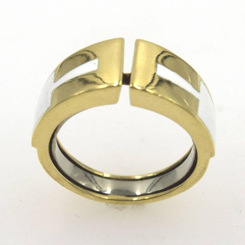 Stylish enamel and 18 karat yellow gold ring by David Webb. This ring circa 1970's features geometric white enamel inlayed in a gold band. The band is size 8.5 and is signed David Webb 18k. 