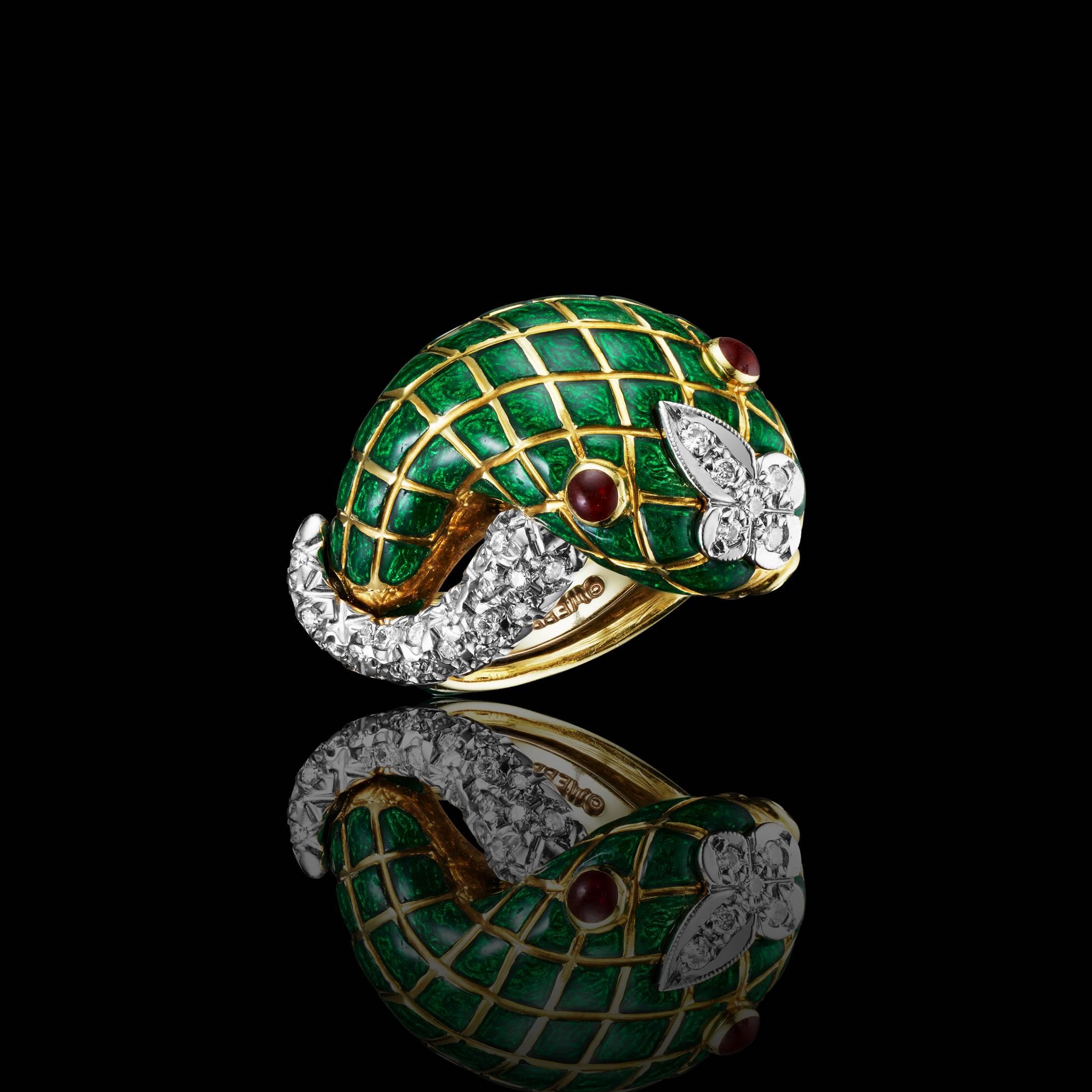 David Webb 18k gold,platinum,diamonds,ruby,and green enamel ring.The green enamel body features the likeness of a rattlesnake.The tell and the nose are made of high quality brillants' cut diamonds on platinum  .The eyes are made of 2 ruby.
-Round