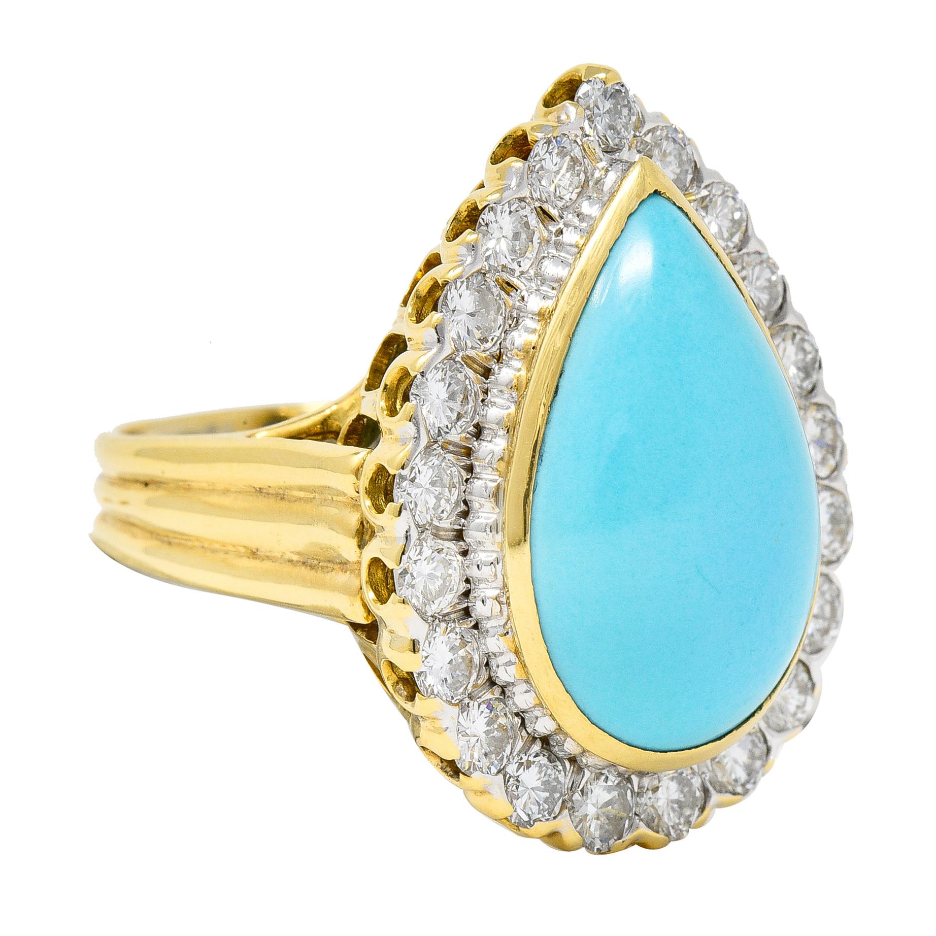 Centering a pear shaped turquoise cabochon measuring 13.0 x 20.0 mm - opaque robin's egg blue. Set in a polished gold bezel with fluted platinum edged and a halo of round brilliant cut diamonds. Weighing approximately 2.10 carats total - G/H color