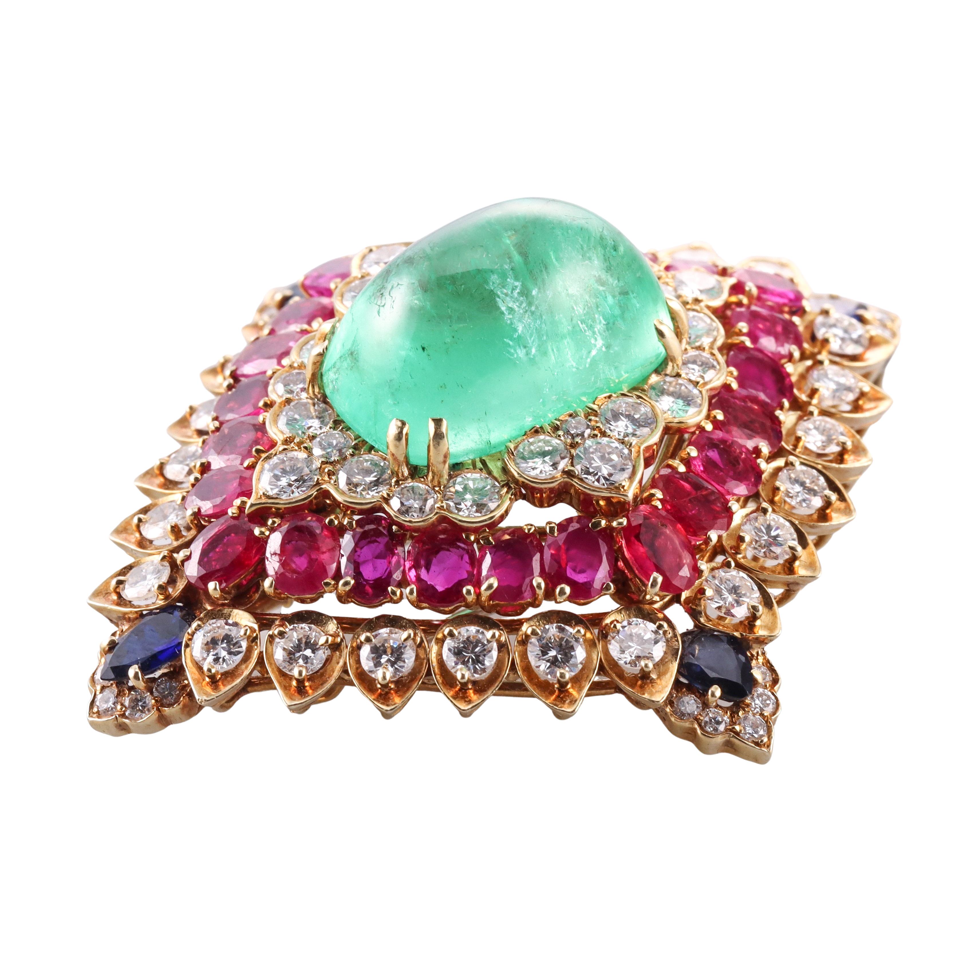 A remarkable 18k gold  brooch by David Webb, featuring center emerald cabochon (stone measures approx. 21.03 x 14 x11.5mm) weighing about 26 carats, surrounded with blue sapphires, rubies and approx. 6 carats in SI1/H diamonds. Few rubies have