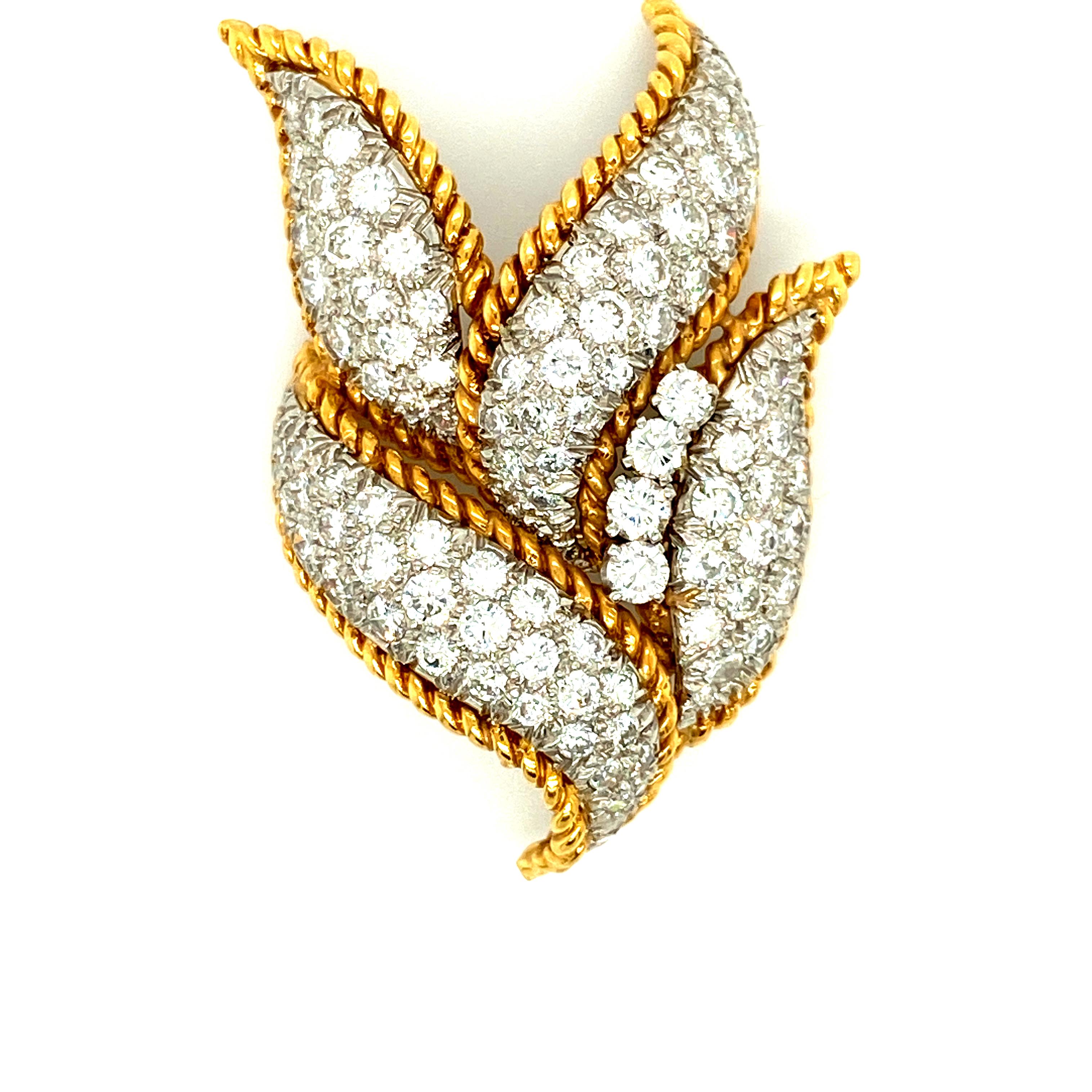 This David Webb brooch was constructed with curved platinum settings housing approximately 5cts of round brilliant diamonds, bounded by 18k yellow gold in a 'woven', rope-like texture in an overall design resembling a cluster of leaves.  This brooch