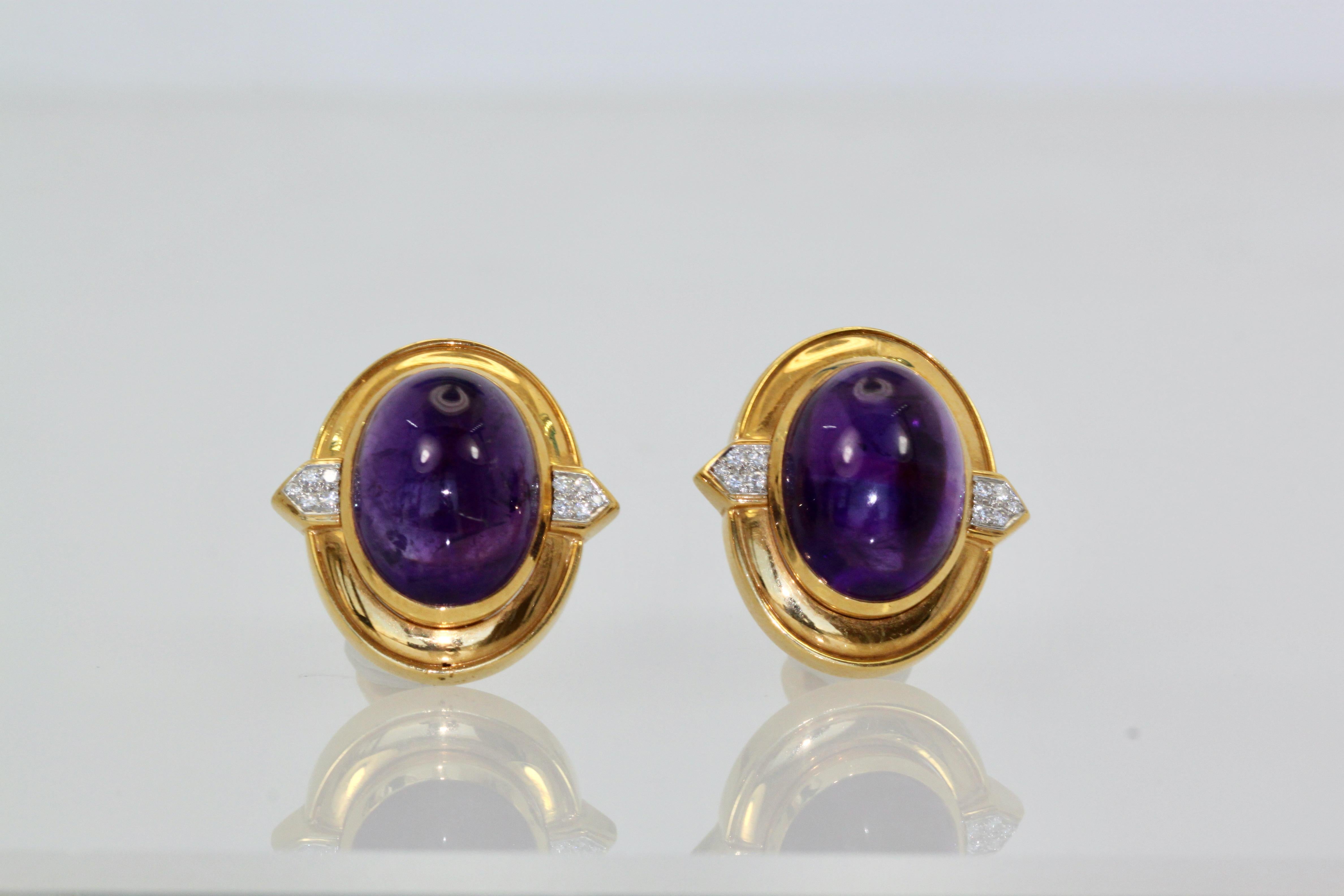 These beautiful David Webb earrings feature Amethyst Cabochons that measure 20.71 cm x 16.5 cm.  They are quite large and the surround measures 23cm x 28cm with a depth of 11.40.  These stones are surrounded by 18K Yellow Gold with two side plaques