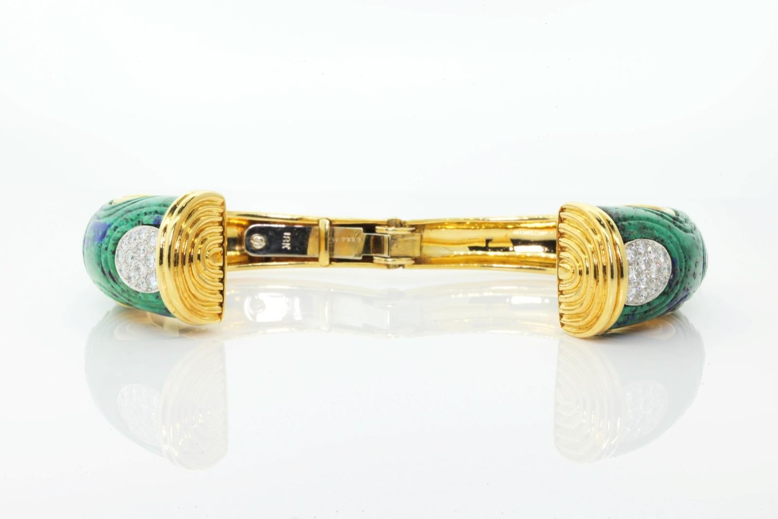 Beautiful and unusual 18KT yellow gold David Webb bangle bracelet.  Two carved domed Azurmalachite stones comprise the top of the bracelet, each set with platinum approximately 2.40 carat of Round Diamond pave insets.  The Azurmalachites are carved