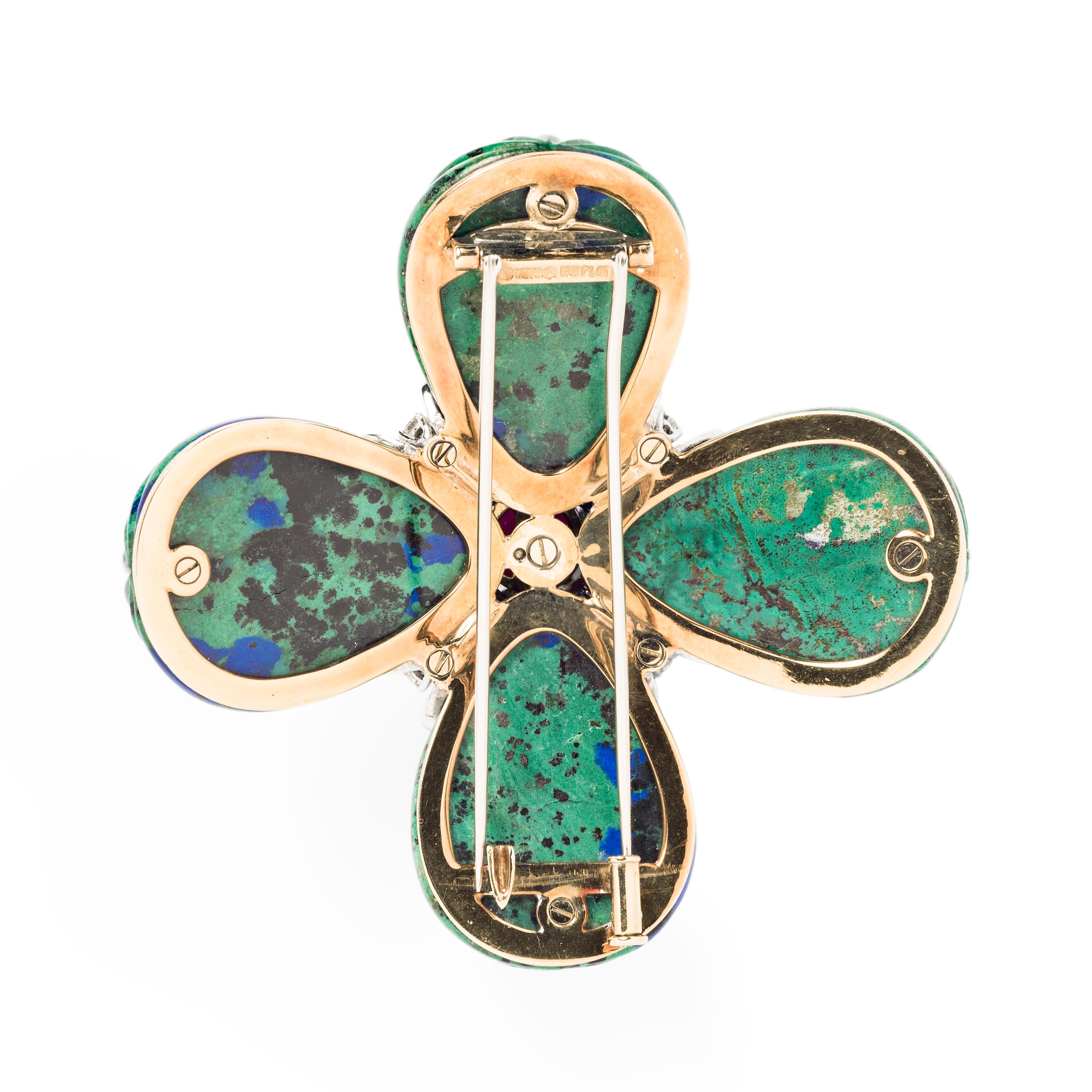 This stylized Maltese Cross from David Webb is composed of four reeded azurmalachite elements surrounding a central cabochon ruby highlighted by round diamonds in a radiating design.

- Approximately 2.63” in diameter 
- Approximately 6.50 carats of