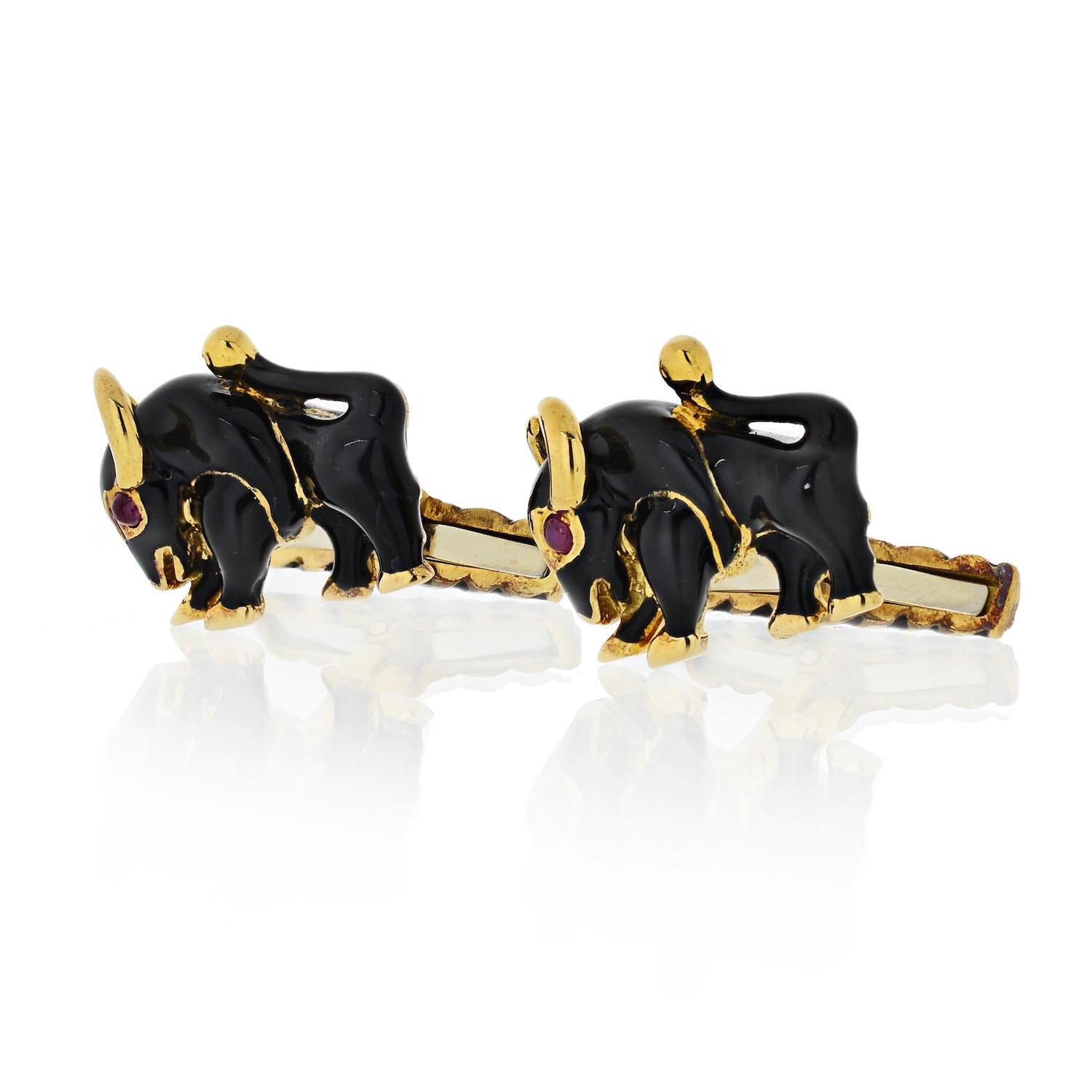 18K Yellow Gold Cuff links made and signed by David Webb. They are vintage from an estate in mint condition having been stored in their original box. They are figural Bulls finished in gleaming dark Cobalt Blue enamel with Cabochon Ruby Eyes. Gold