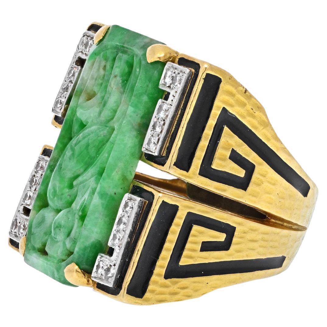 Large statement ring made with carved green jade in the center, flanked by pave set diamonds. Wide yellow gold shank decorated with black enameling. From the Ancient World collection you can wear this beauty to dinner or out and about town. 
Overall