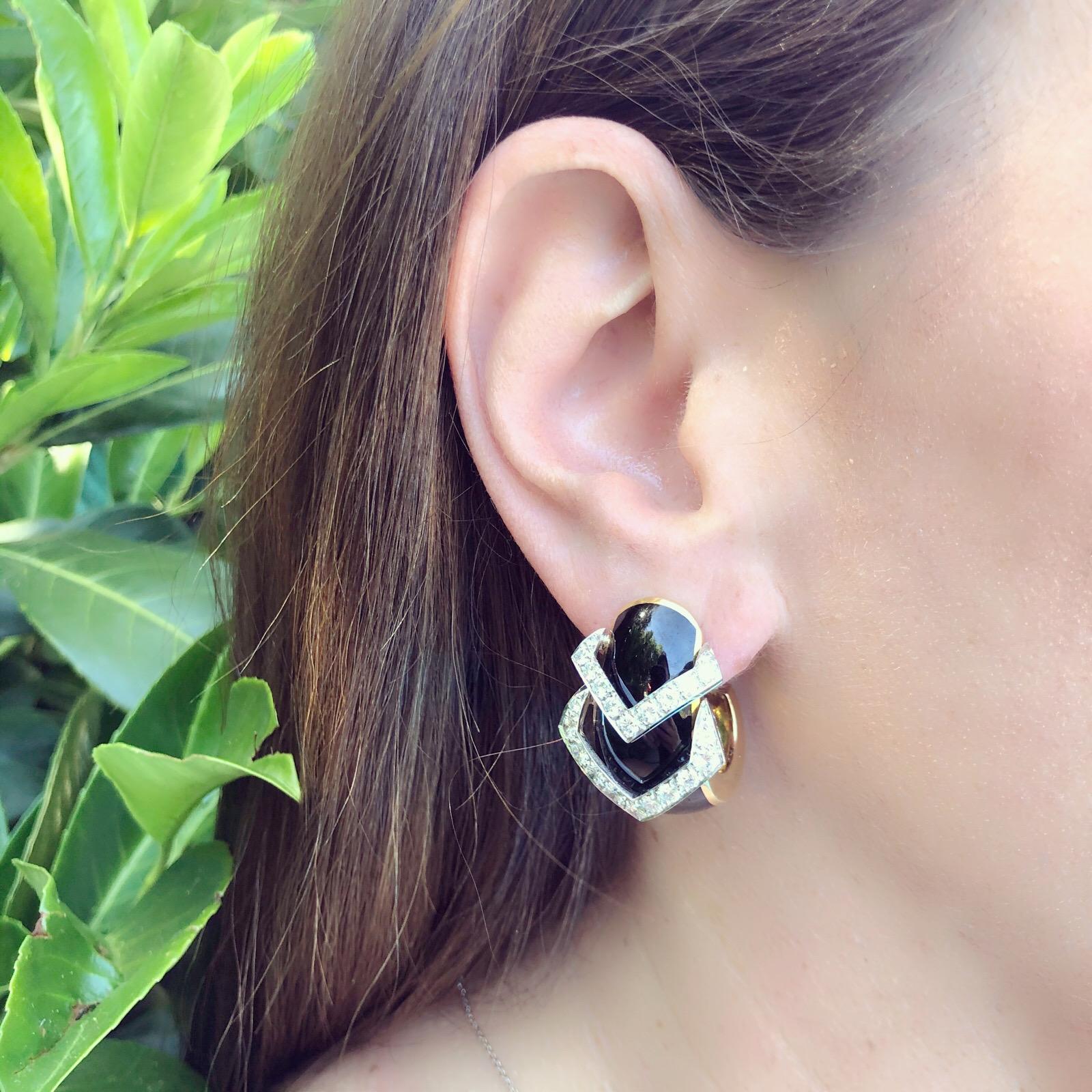 David Webb bold half hoop earrings of black enamel and round brilliant cut diamonds set in 2 mobile detailed points that adds movement to the lucky wearer.  The earrings measure approximately 1.25