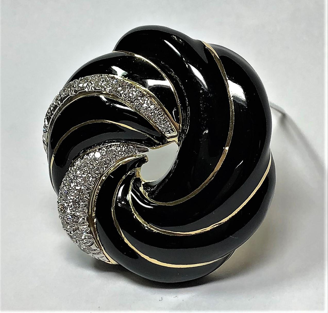 Made of 18K Yellow Gold with black enamel swirls divided by gold, and with two platinum
plates set with assorted round brilliant cut diamonds weighing an approximate total of 2.5ct
of overall F/G color and VS1 Clarity. The brooch measure 1 5/8 inch