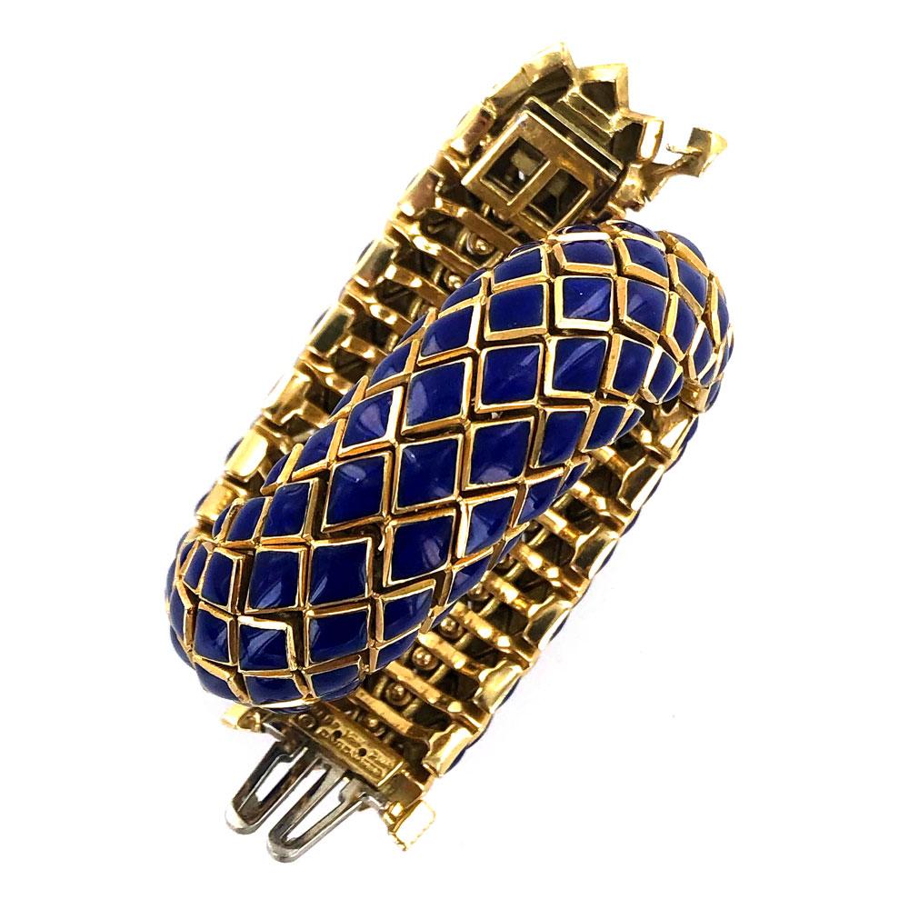 Gorgeous work of art by David Webb. The flexible snake like scale bracelet is hand crafted in 18 karat yellow gold and blue enamel. The bracelet is in excellent condition, measures 7.0 inches in length, 16mm in width, and is signed Webb 18k plat