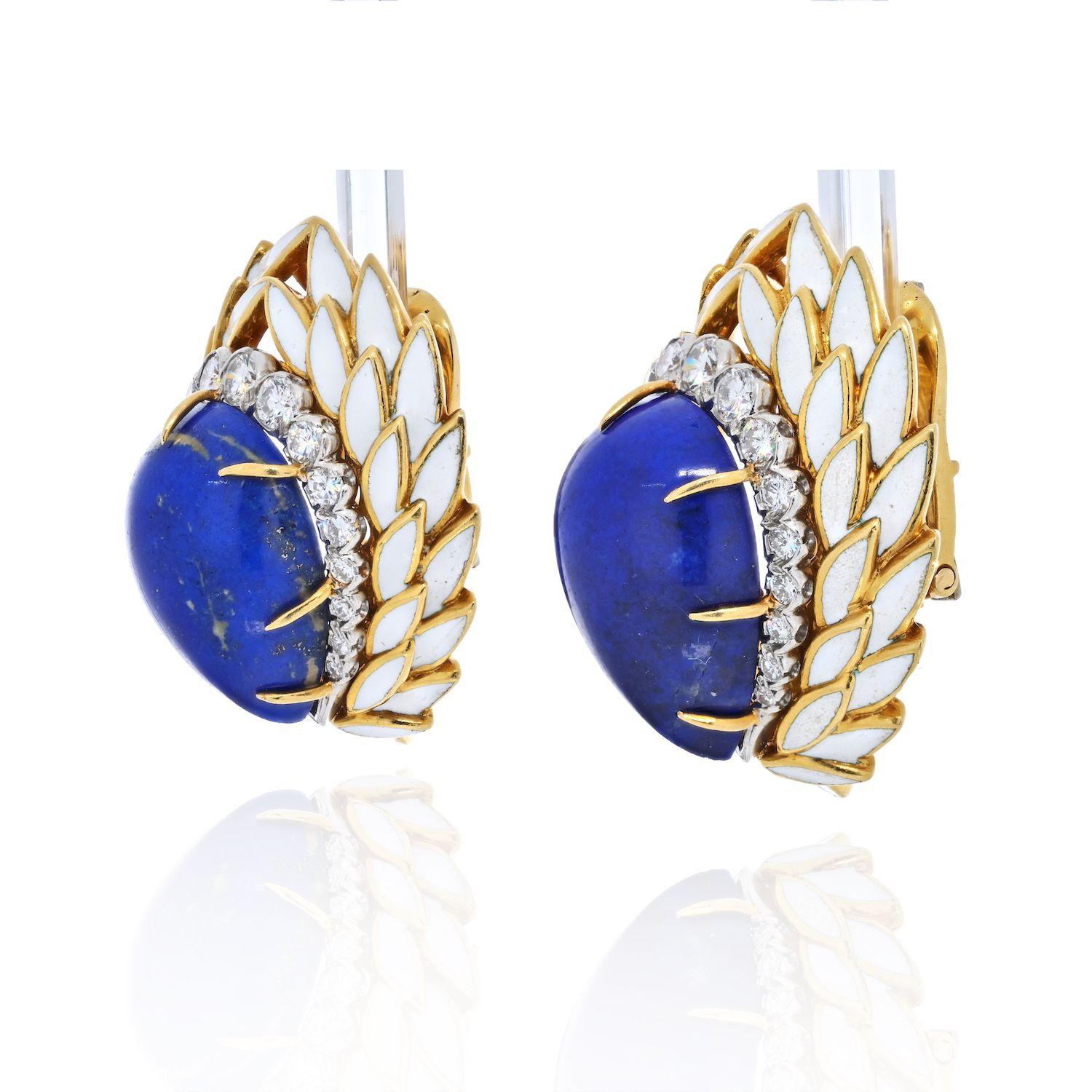 These David Webb earrings have everything a vintage Webb jewel can offer: color, dimension, style, design, contrast, age. The carved gem-quality lapis lazuli pear cut cabochons held within yellow gold and opaque white enamel lotus petals, accented