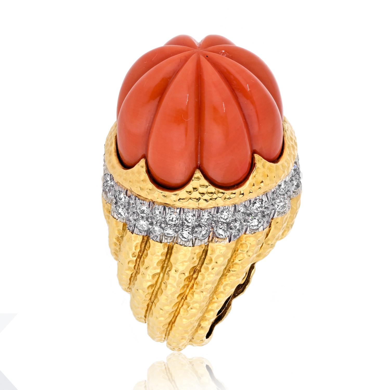 Immerse yourself in the luxurious beauty of the David Webb Platinum & 18K Yellow Gold Carved Coral Diamond Rim Ring, a statement piece that showcases a significant coral centerpiece surrounded by sparkling round diamonds.

**Key Features:**

1.