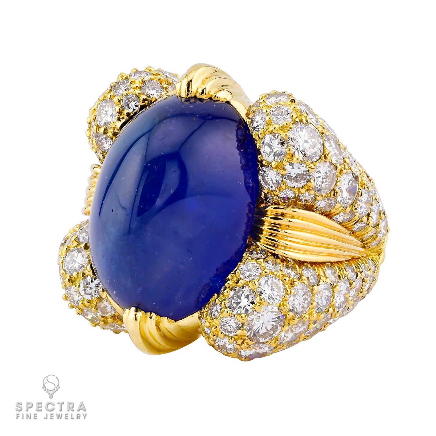 The David Webb Cabochon Sapphire Diamond Ring is a luxurious and exquisite piece of jewelry that epitomizes elegance and sophistication. At its heart lies a stunning cabochon sapphire, known for its smooth, polished surface and rich, deep blue hue.