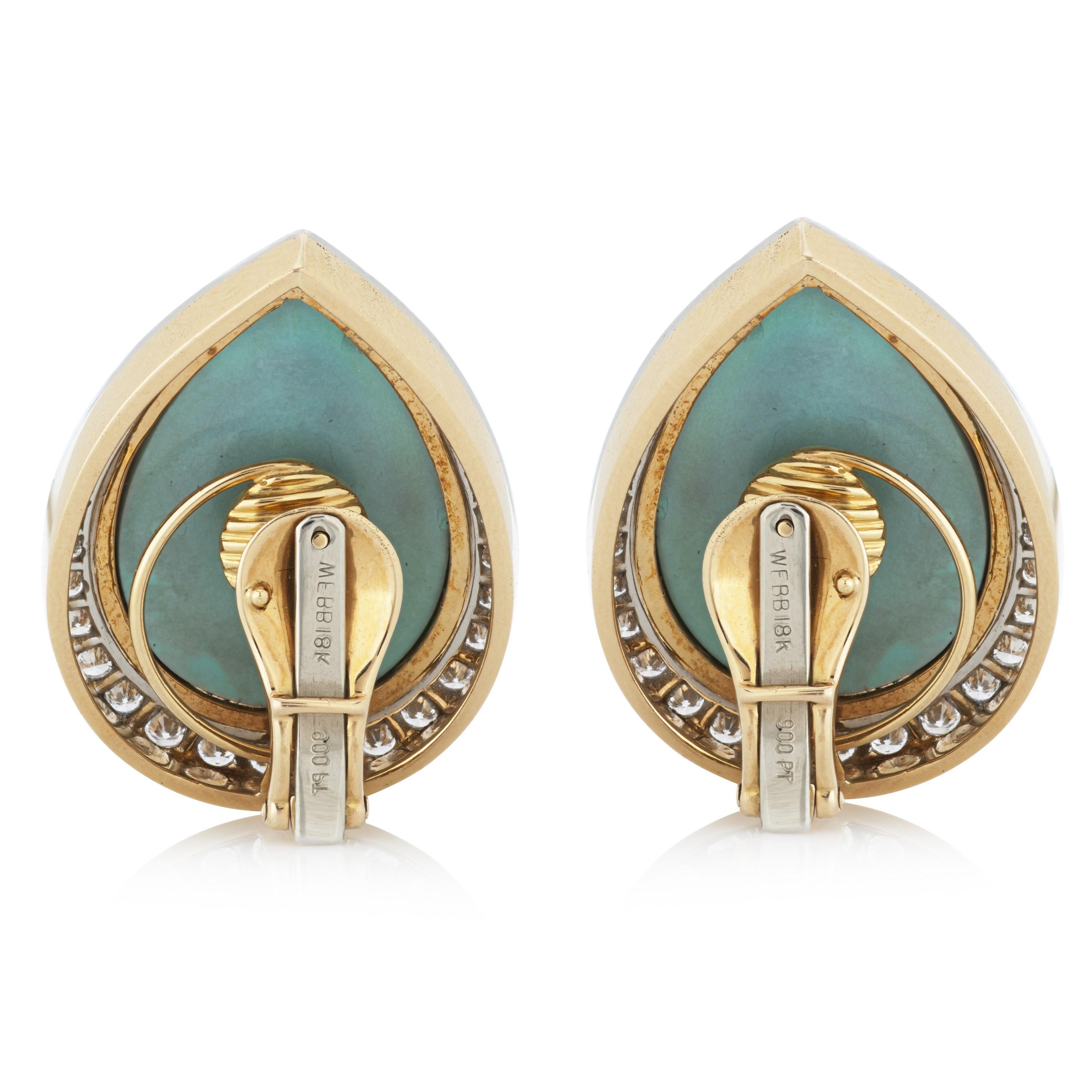 David Webb cabochon turquoise and diamond clip on earrings in 18k yellow gold and platinum, accompanied by a David Webb box and David Webb Certificate of Authenticity.  

The center stones of these earrings are two pieces of pear shaped cabochon