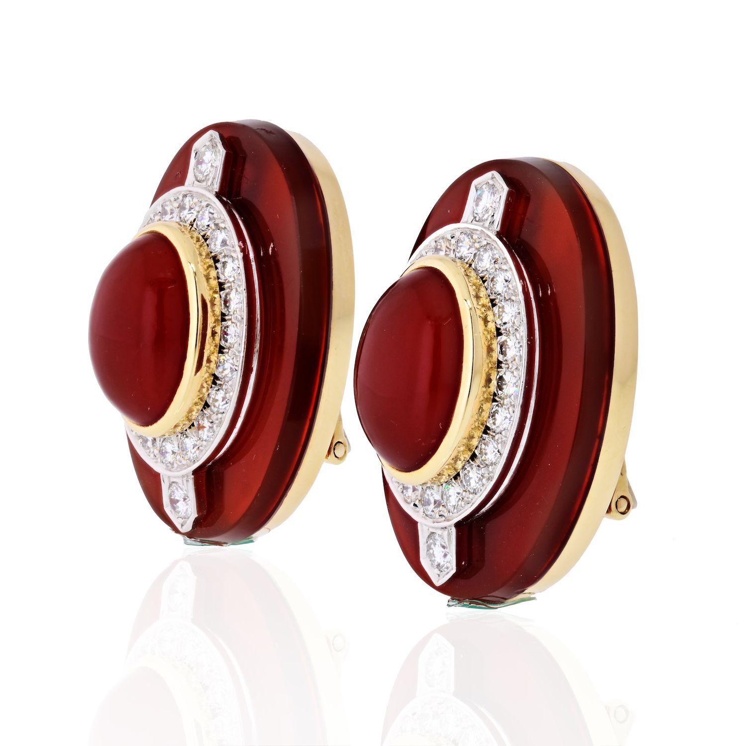 Containing two oval shape cabochon cut carnelian measuring approximately 14.75 x 10.80 x 7.20 mm and 44 round brilliant cut diamonds weighing approximately 1.50 carats total. Earring length 1.1 inches.
