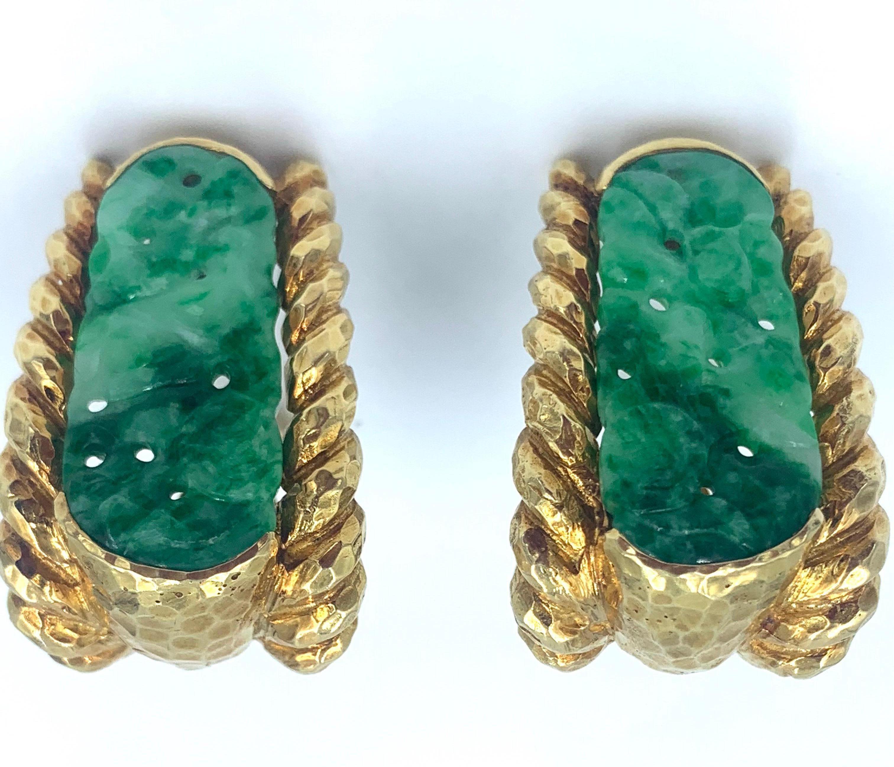  Hand hammered 18 karat yellow gold earrings set with carved and pierced jade. These earrings showcase exceptional  attention to detail. Created by David Webb.
Signed Webb 