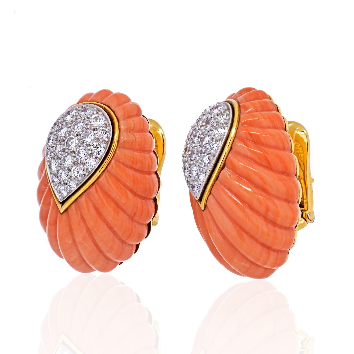 Carved coral and diamond clip-on earrings by David Webb. 

From David Webb, a pair of diamond and fluted coral earrings. The earrings boast brilliant cut diamonds weighing approximately 2.50 carats. Set in 18 Karat gold and platinum. 
1 1/8 High 5/8