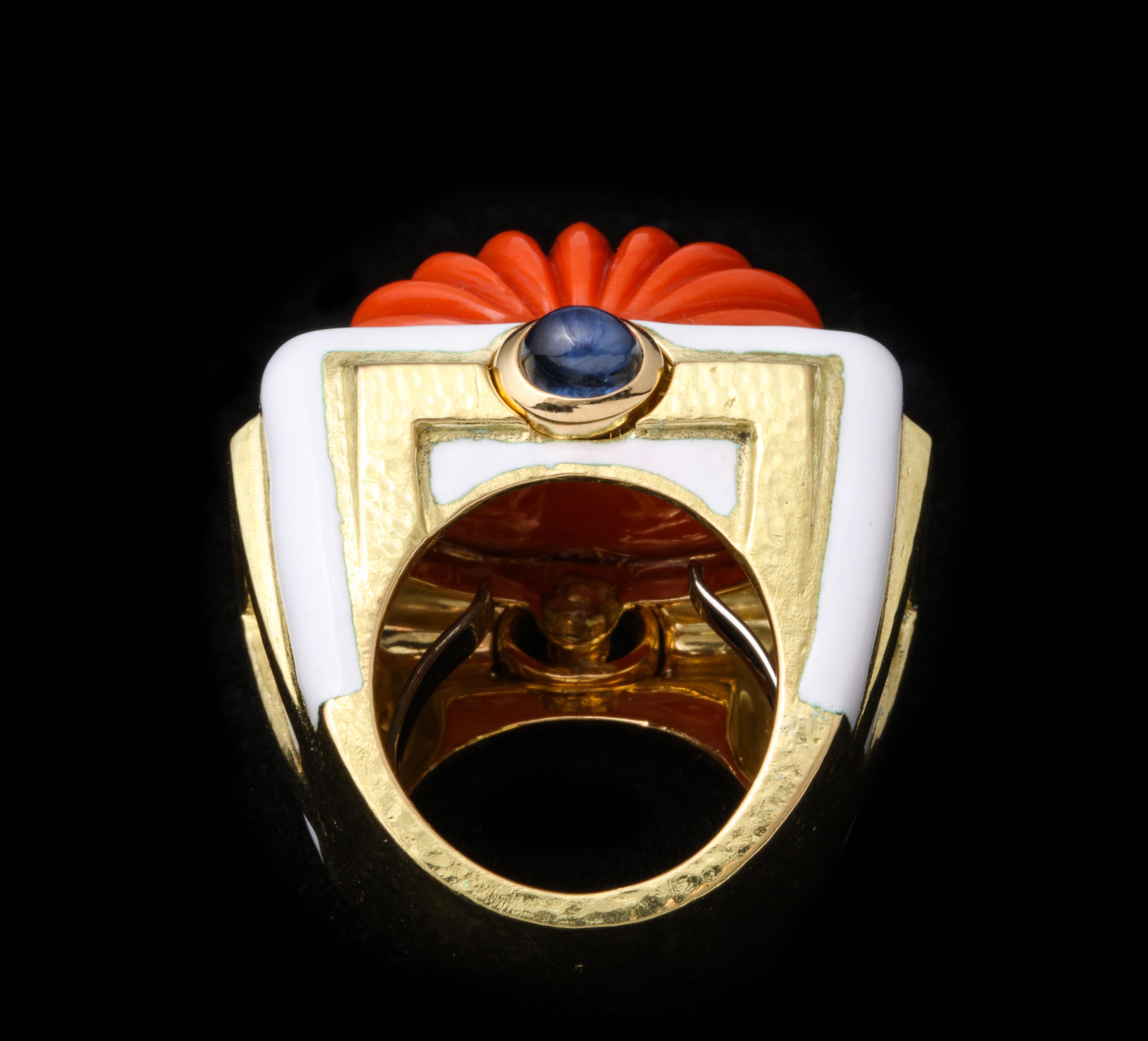 David Webb Carved Coral Ring 

Set with a carved coral, cabochon sapphire, white enamel on 18 karat gold

Signed David Webb. With certificate of authenticity

