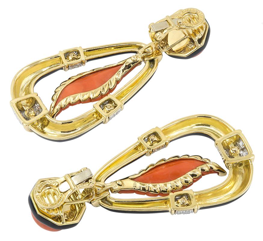 DAVID WEBB Carved Coral Diamond Earrings
An 18 yellow gold and platinum accented leaf dangling ear clips, set with diamonds, black enamel, and carved and cabochon coral, signed David Webb.
Measures approx. 2.5″ in length
Stamped “DAVID WEBB”; circa
