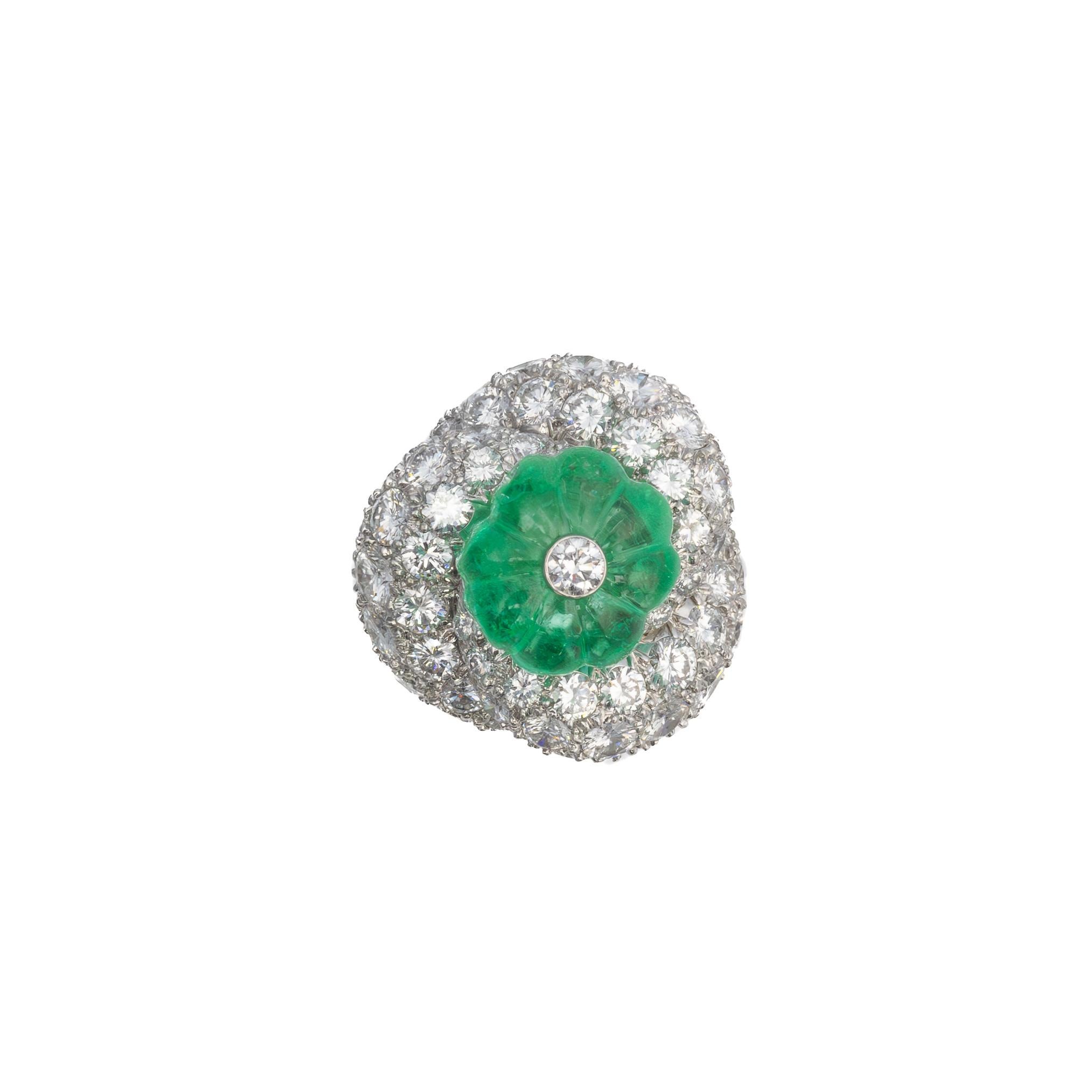 David Webb Carved Emerald and Diamond Platinum Ring

This exquisite David Webb ring is a masterpiece of bold design and unparalleled craftsmanship. At its center sits a beautifully carved emerald, radiating vibrant green hues, accented by a single
