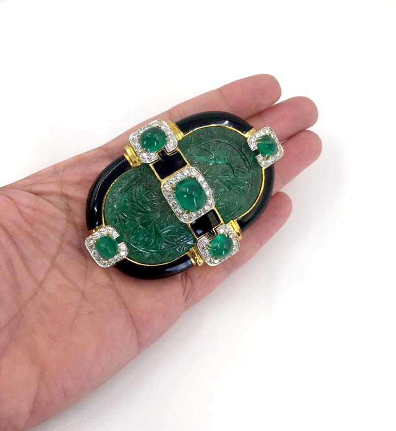 DAVID WEBB Carved Emerald Convertible Pendant Brooch in 18k Gold and Platinum.

A convertible pendant and brooch dating from the 1980s by David Webb featuring emeralds, diamonds, black enamel, and mixed metals. The look is exemplary of the decade,