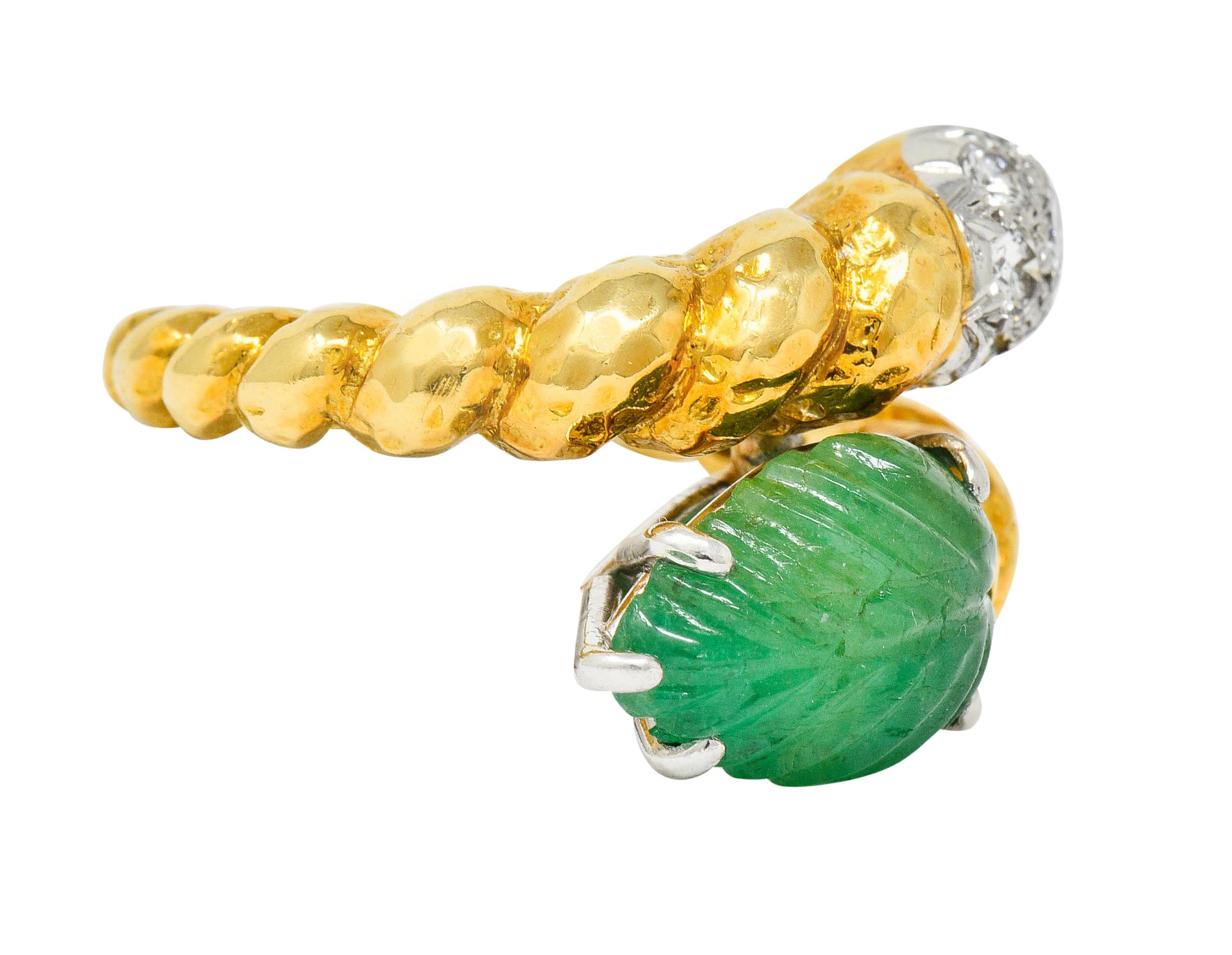 Gold bypass ring designed as a twisted rope motif with a slight hammered finish
Featuring a deeply carved emerald, basket set in platinum, and depicting a stylized leaf measuring approximately 12.0 x 8.5 mm

Translucent with natural inclusions and