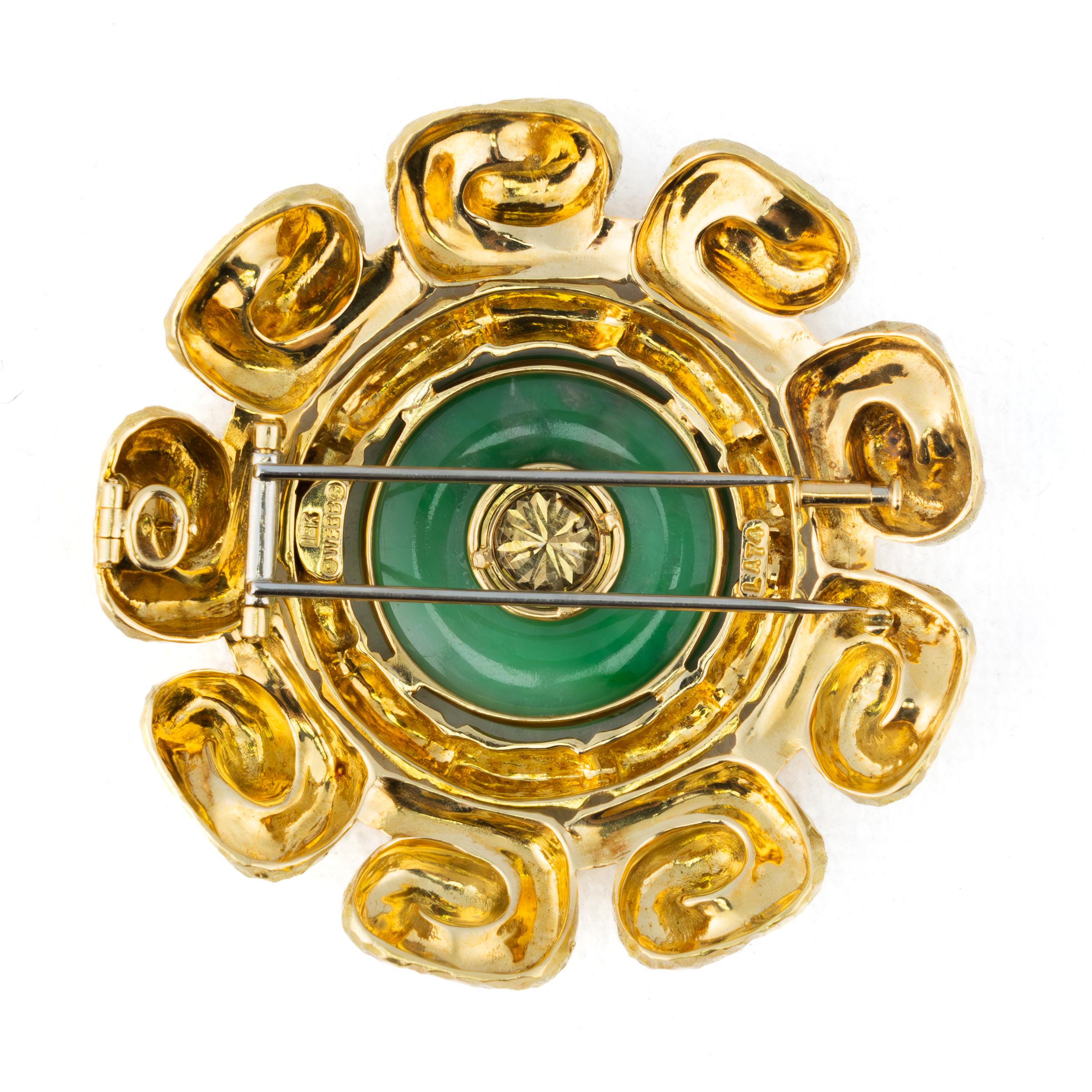 David Webb Carved Jade & Diamond Disc Brooch

An artistic marvel by David Webb, this striking brooch showcases a vibrant carved jade disc at its center, encapsulating the essence of timeless elegance. Framed in rich 18K yellow gold with a