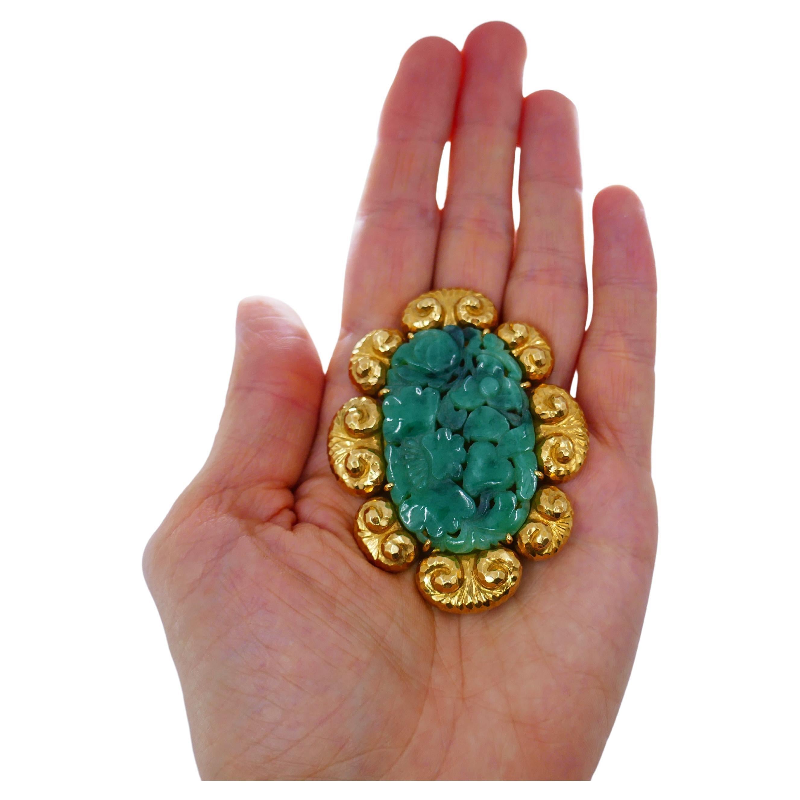 A gorgeous David Webb pendant and brooch, made of carved jade and 18k gold. The floral motif jade is mounted in a hammered gold frame. This substantial piece is a part of Ancient World collection. The pendant is equipped with a double pin clasp and